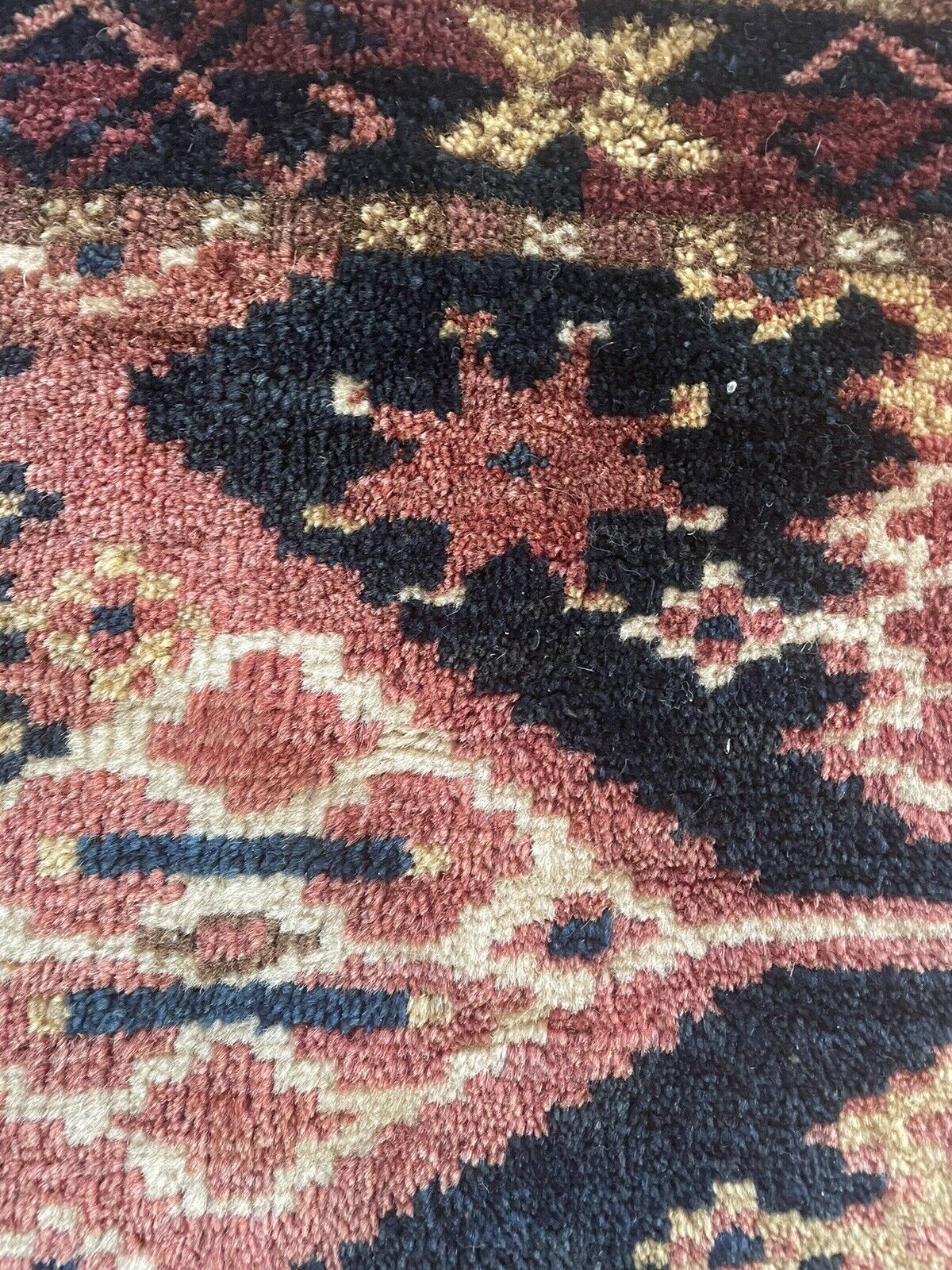 Close-up of age wear on Handmade Antique Afghan Beshir Collectible Chuval Rug - Detailed view showing signs of age wear, which add to the rug's authenticity and character, while also highlighting its resilience.