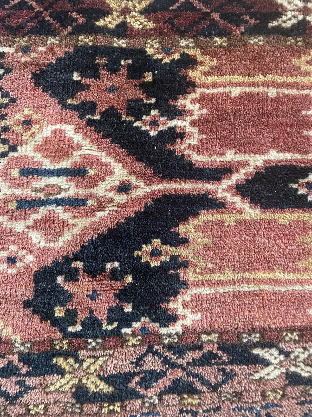 Close-up of color palette on Handmade Antique Afghan Beshir Collectible Chuval Rug - Detailed view showcasing the color palette of the rug, including red, black, and beige tones that create a harmonious visual appeal.