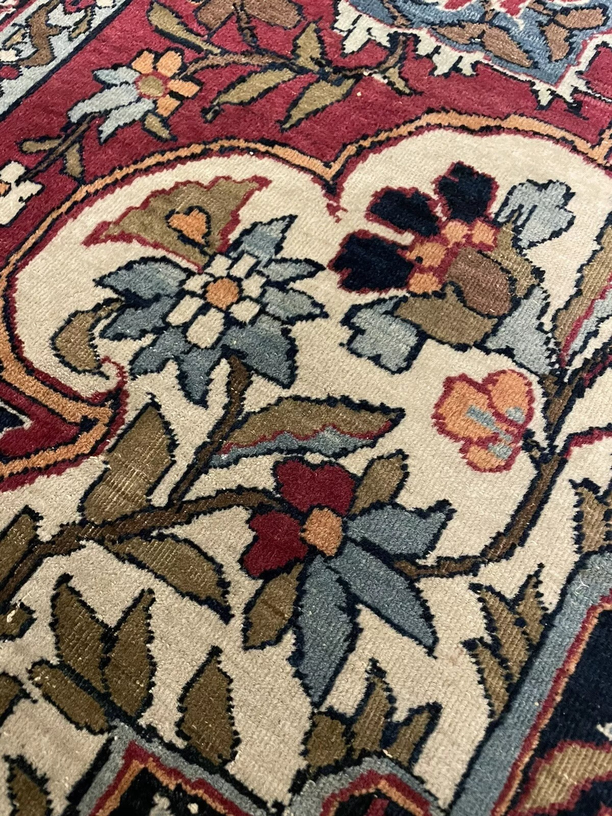 Detailed corner view of an antique Kerman Lavar wool rug