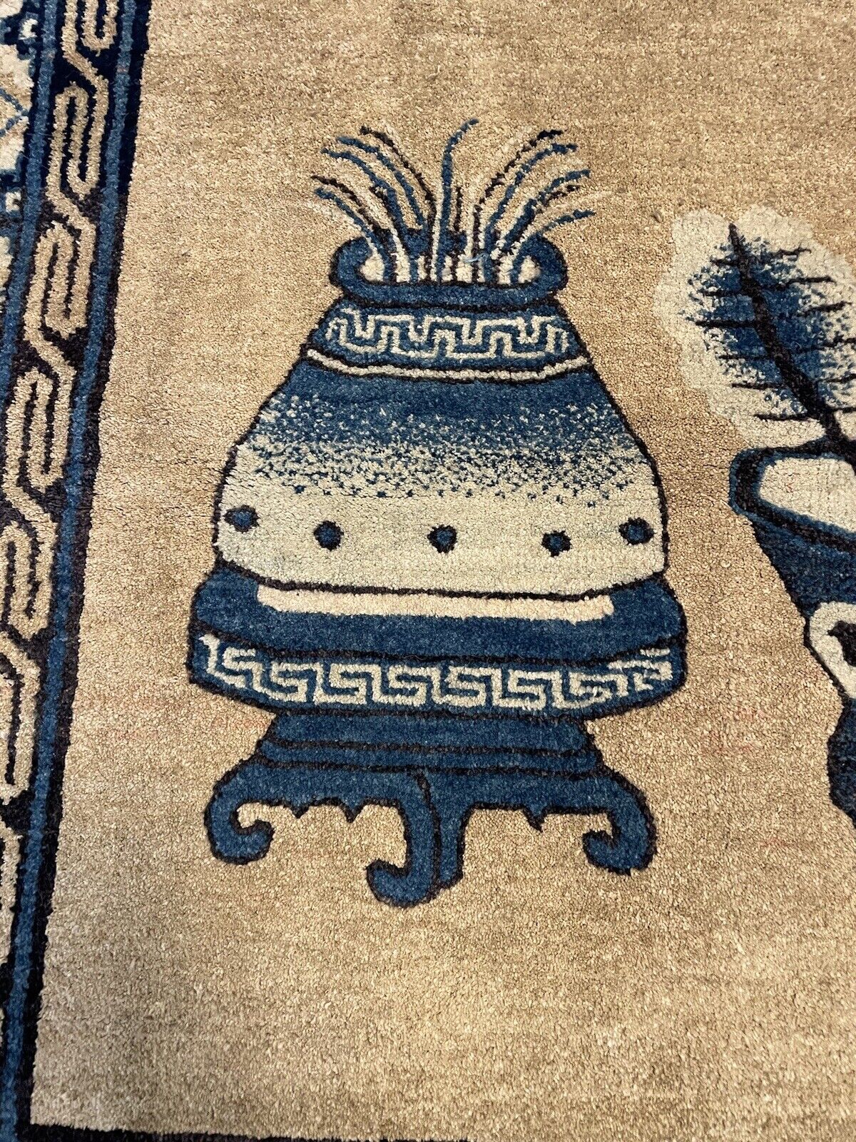 Vintage Chinese rug featuring elegant vases and traditional patterns