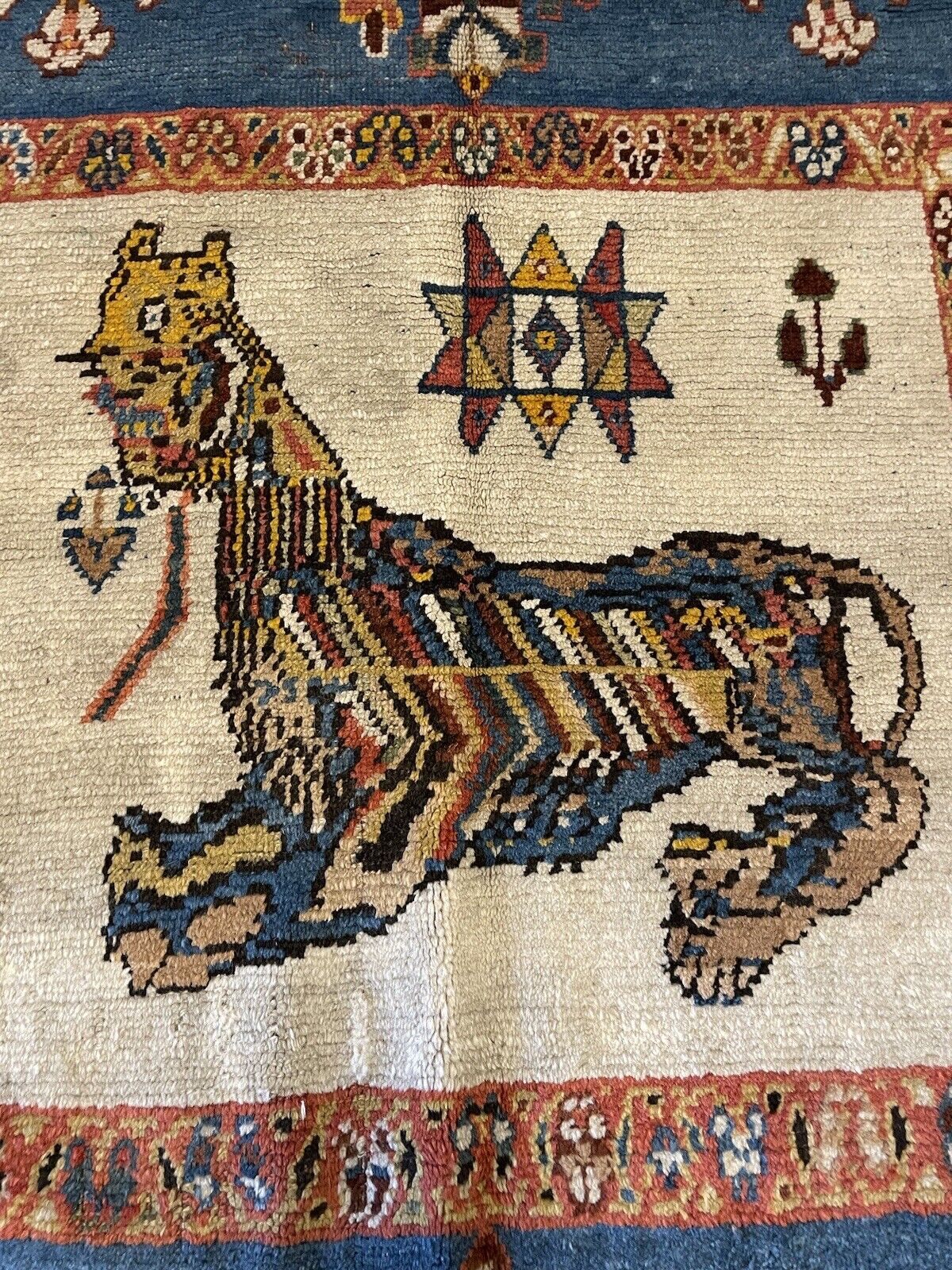 Aged but well-preserved handmade tribal wool rug