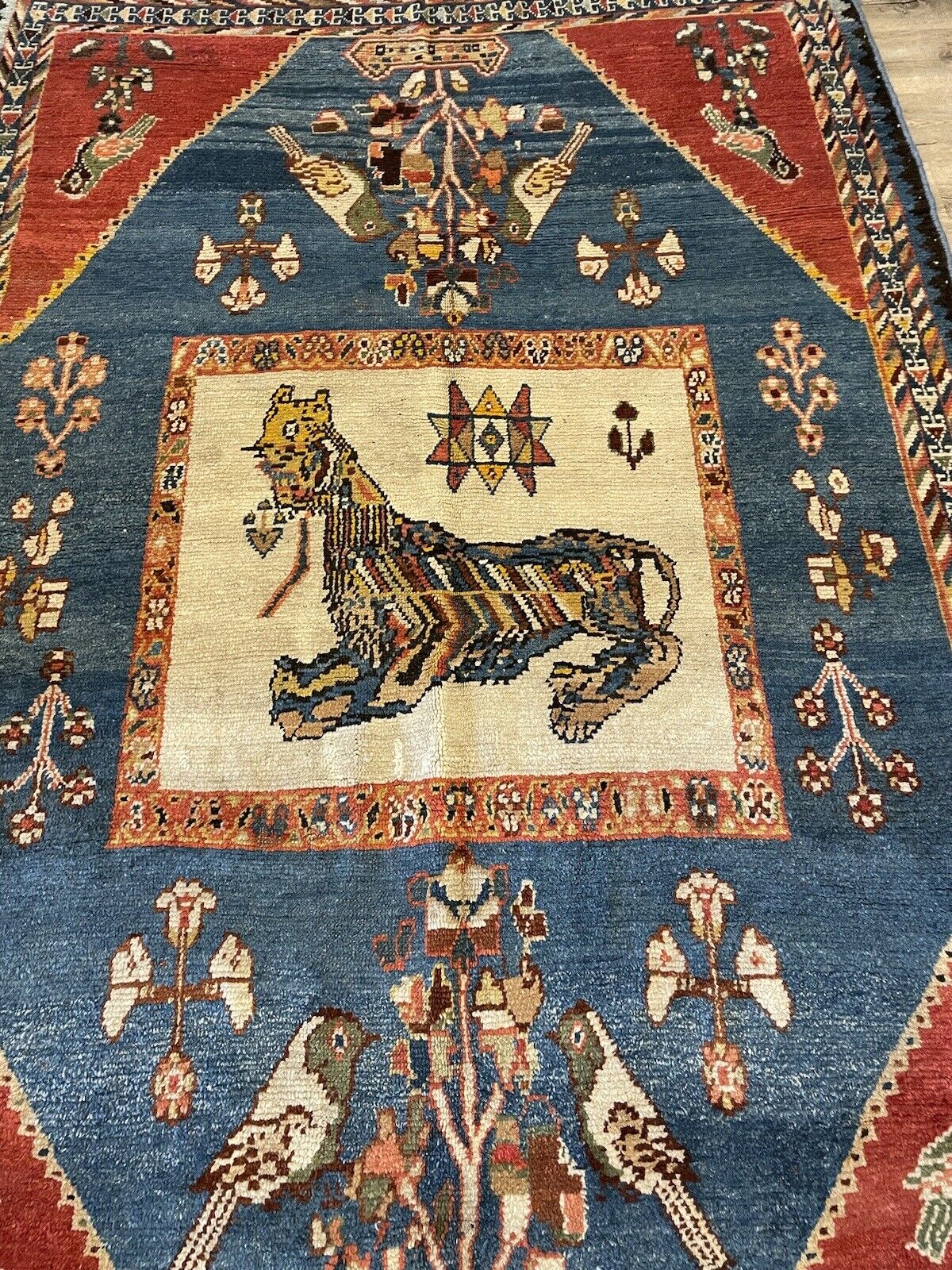 Authentic early 20th-century wool rug with rustic folk-art designs