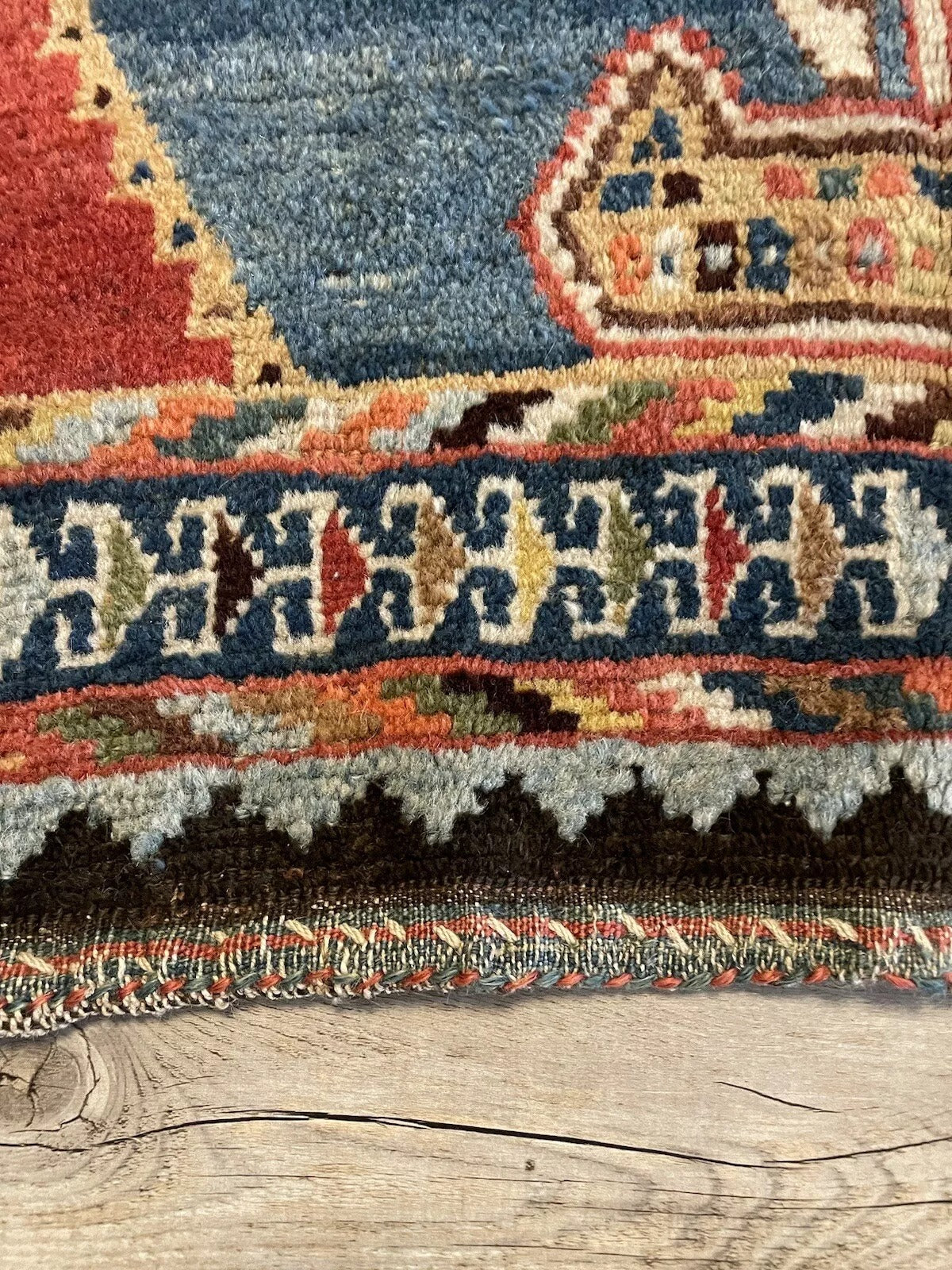 Gabbeh rug with deep blues, reds, and beige in a striking design