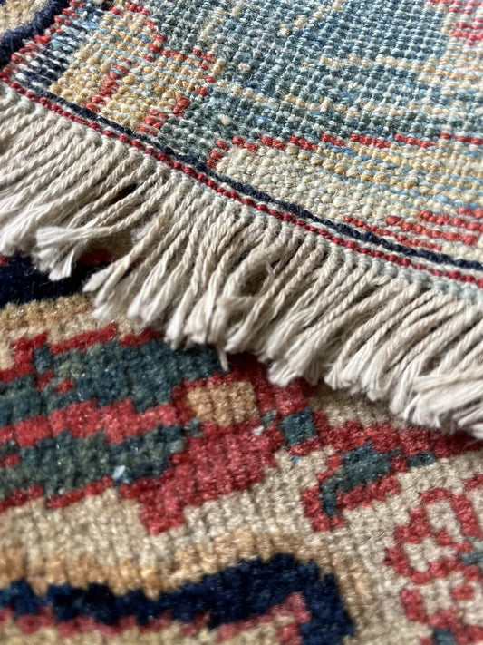 Close-up of intricate floral motifs on a collectible antique rug