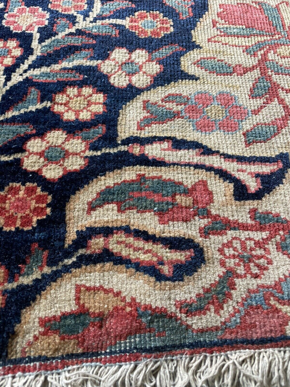 Elegant red and blue antique rug with beige accents