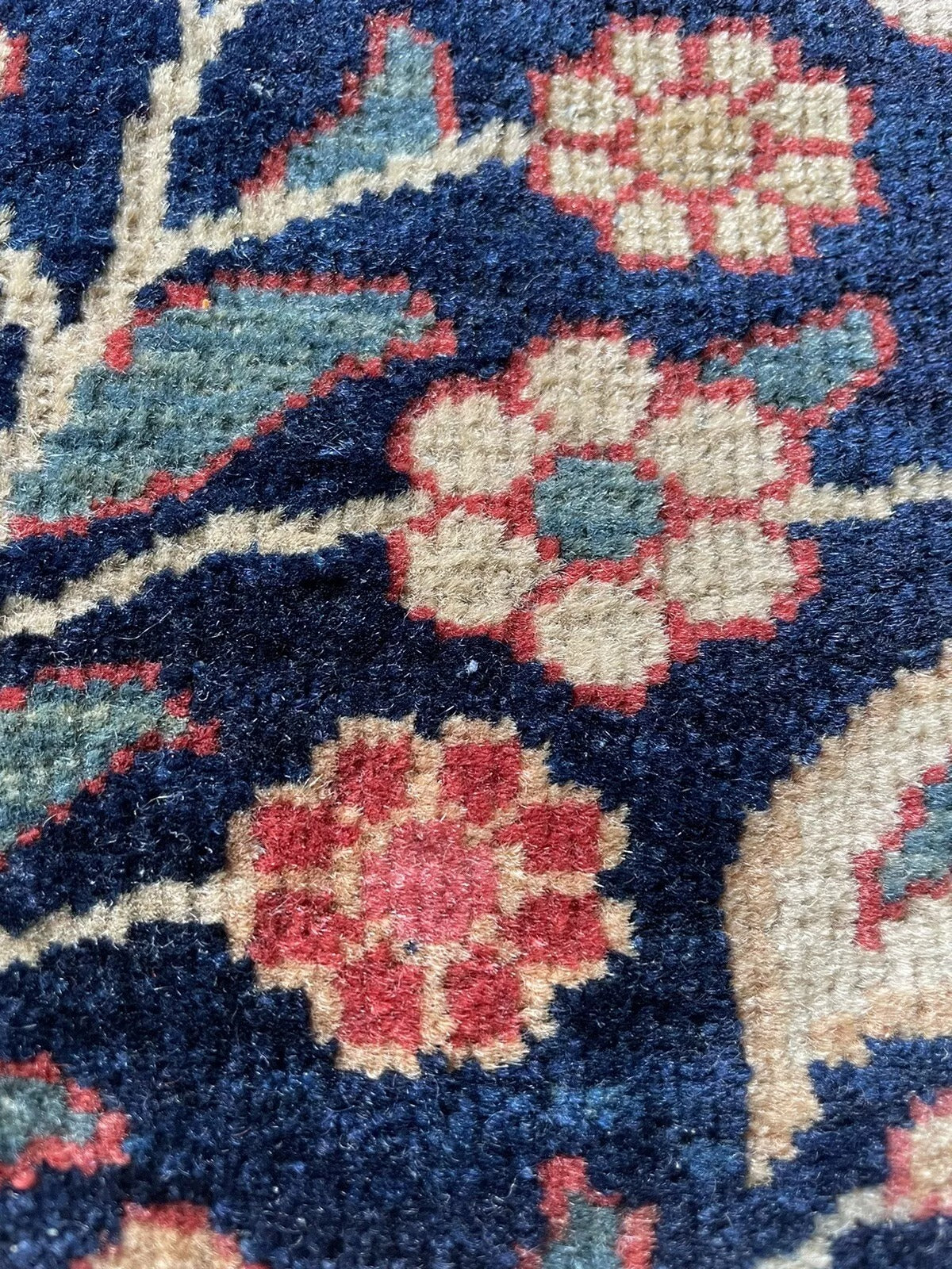 Compact antique rug with a delicate and detailed floral pattern