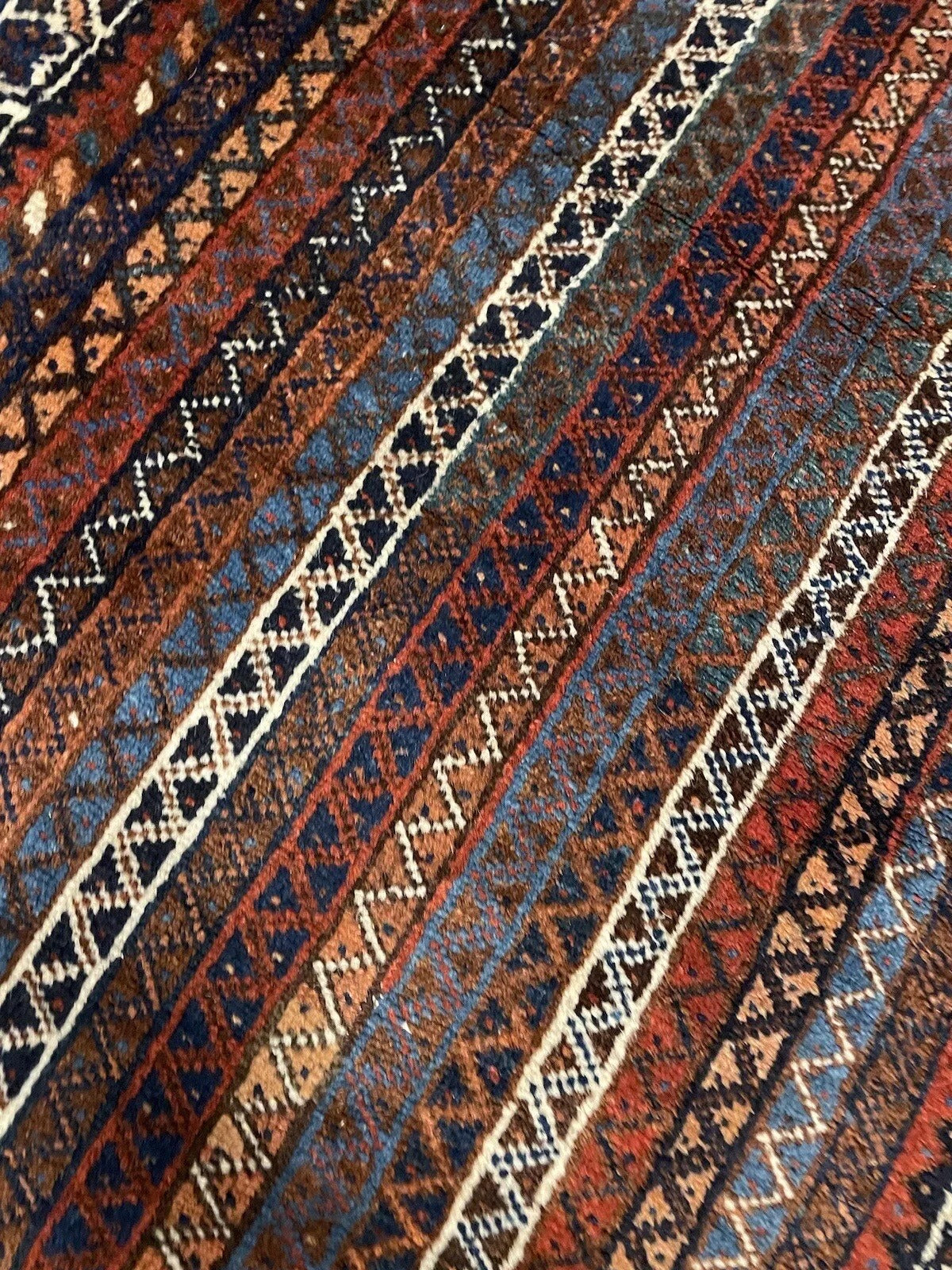 Hand-knotted Persian wool rug with decorative fringes