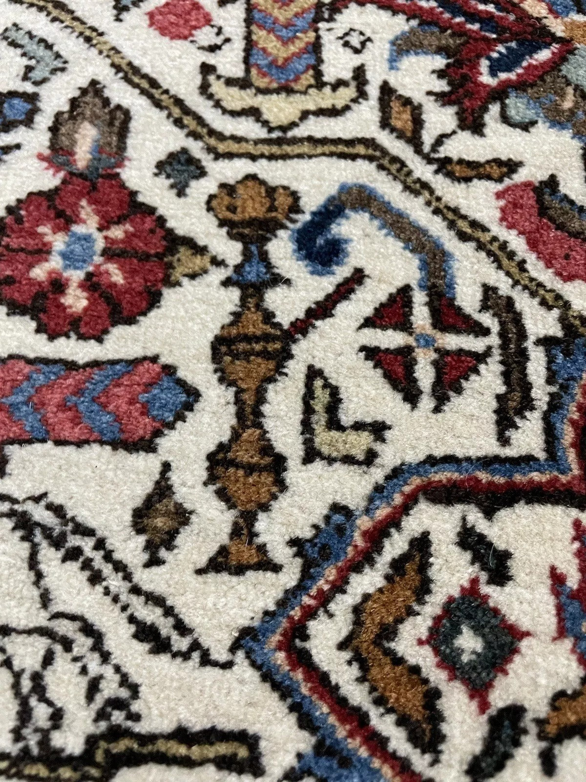 Handwoven Persian wool rug in red, blue, beige, and gold tones