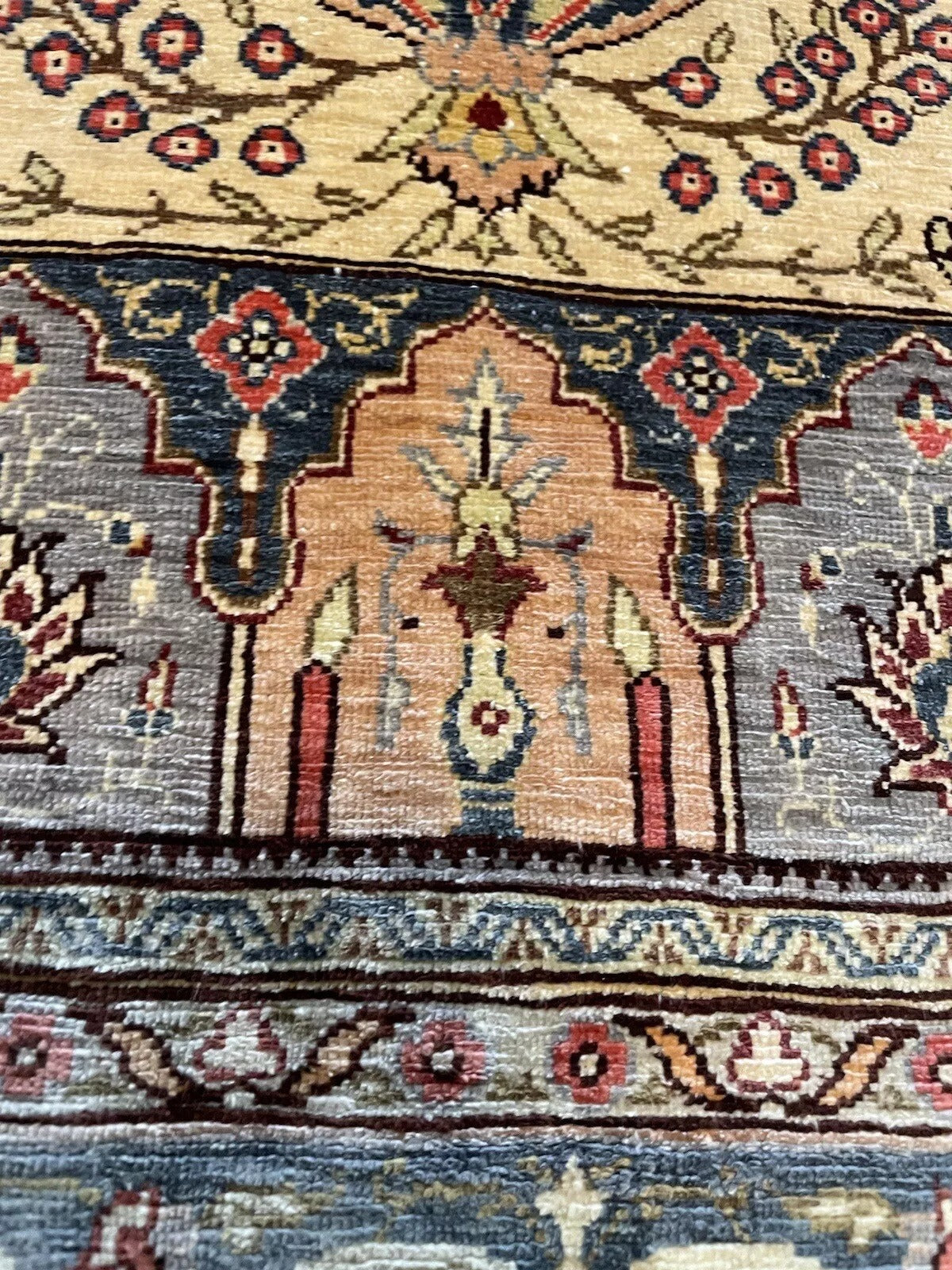 Handwoven Turkish silk rug with rich red, blue, and beige hues