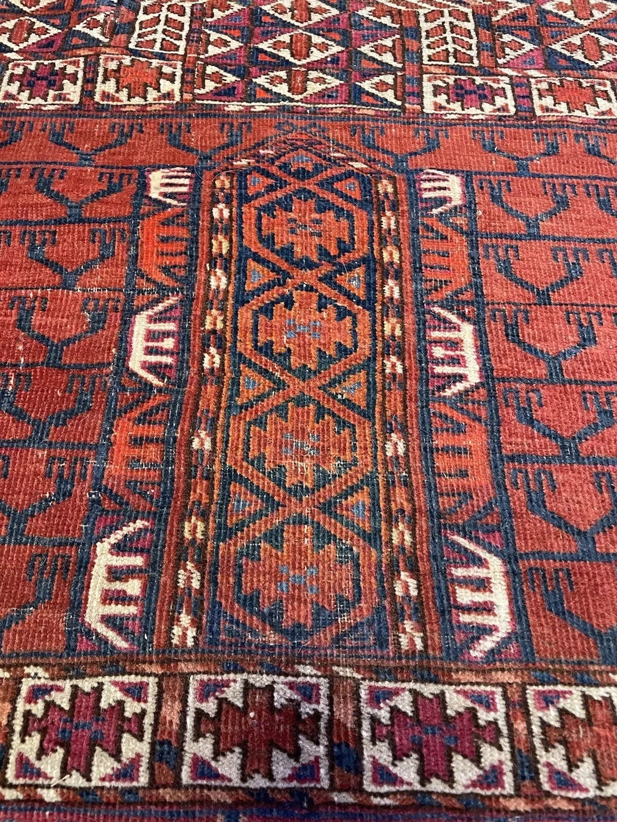 Antique Turkmen rug with symbolic tribal motifs