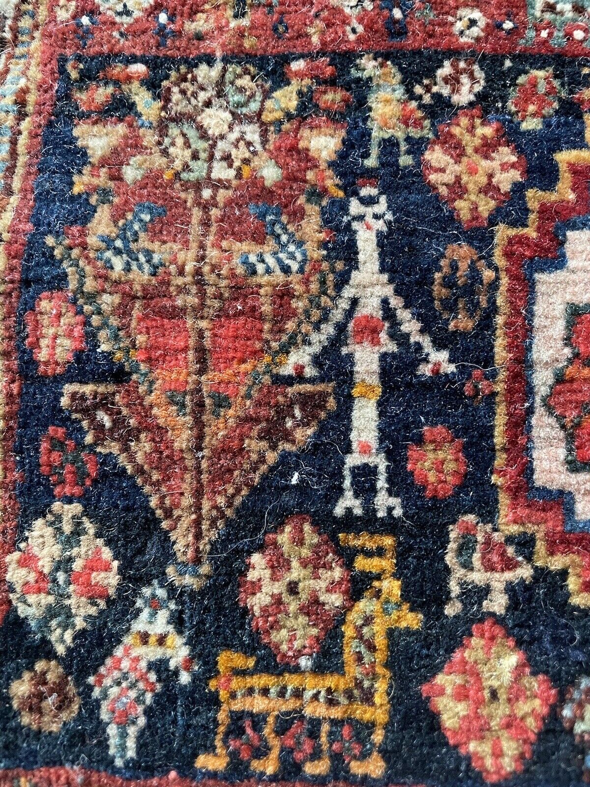 Rich red, blue, and beige hues on a vintage Gashkai rug