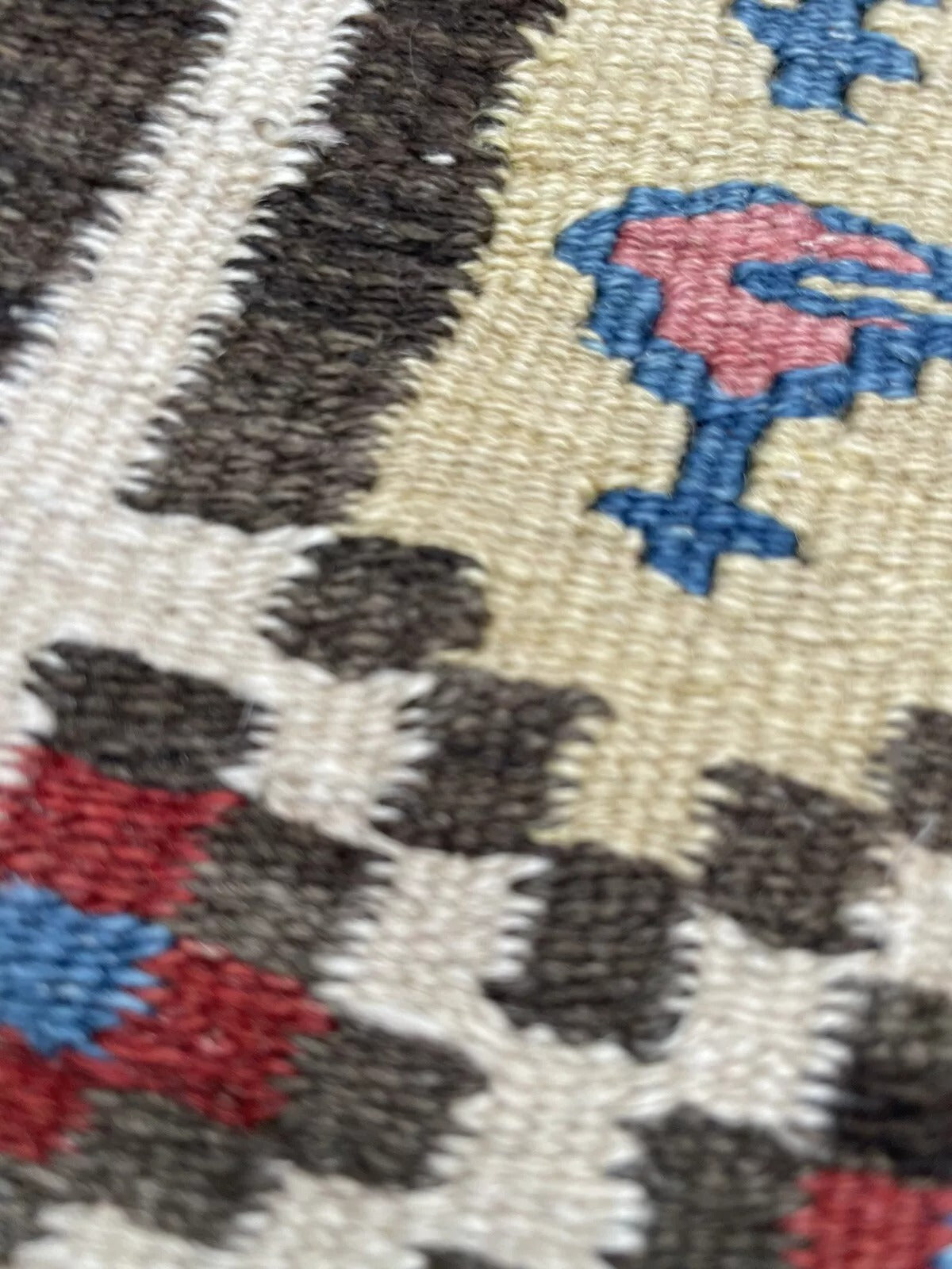 Close-up of intricate border motifs on a Gashkai flatweave rug