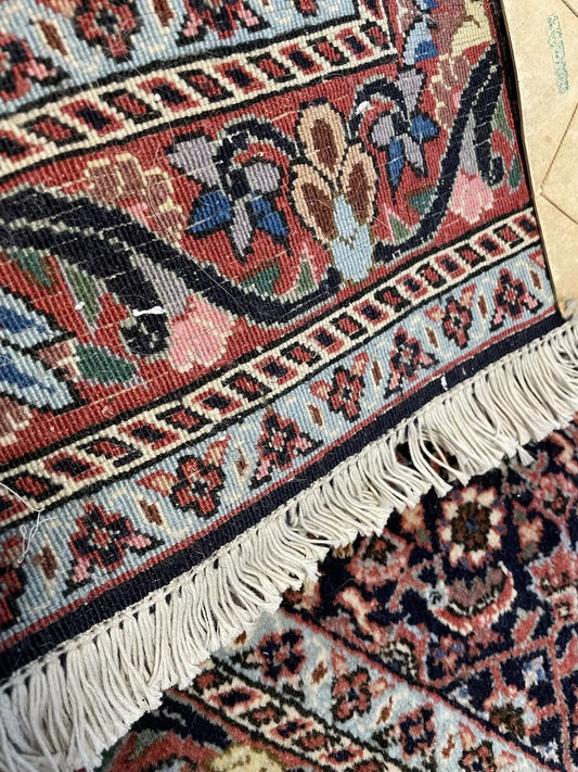 Close-up of the detailed floral motifs on a vintage wool rug