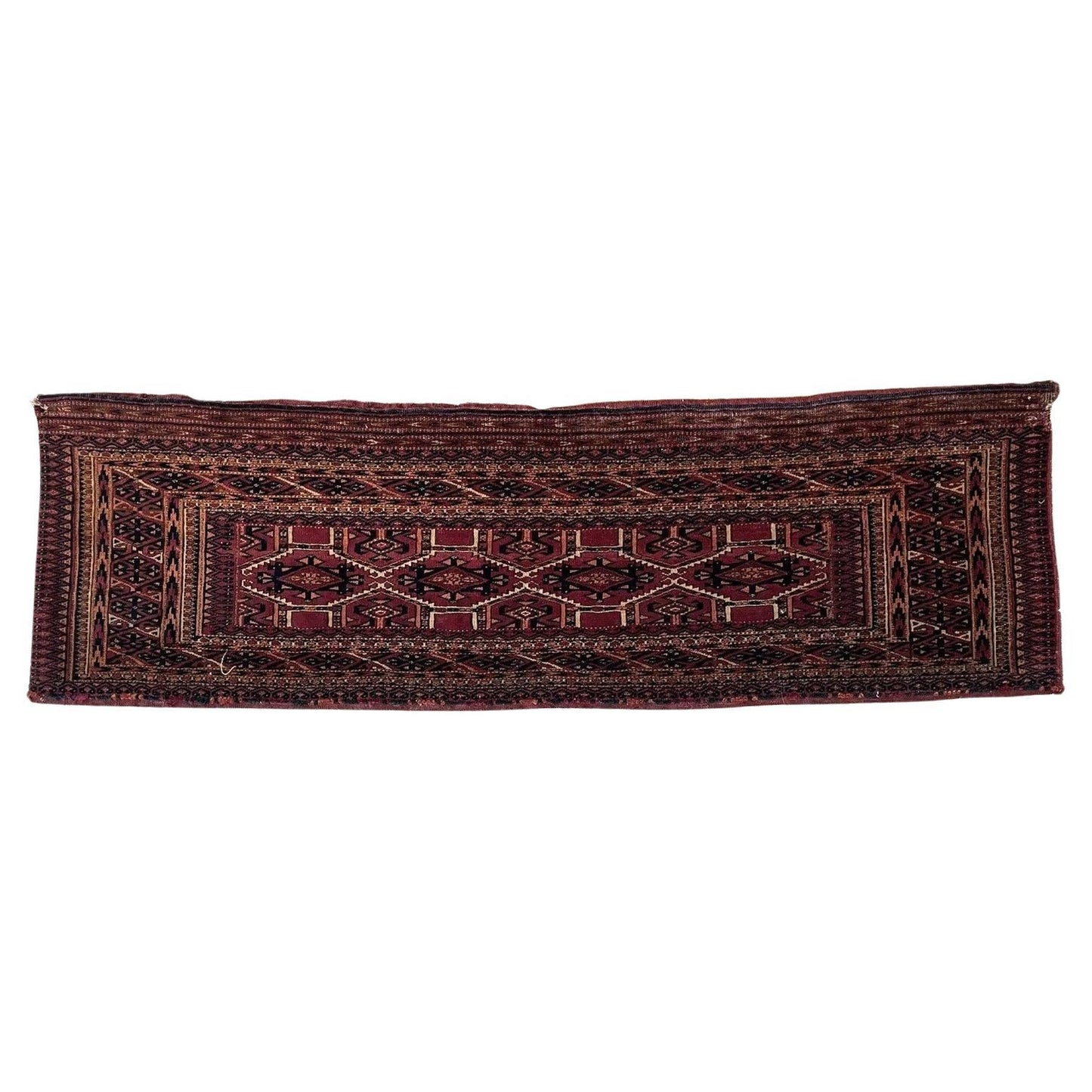 Close-up of antique Turkmen Yomud rug with intricate red and black patterns