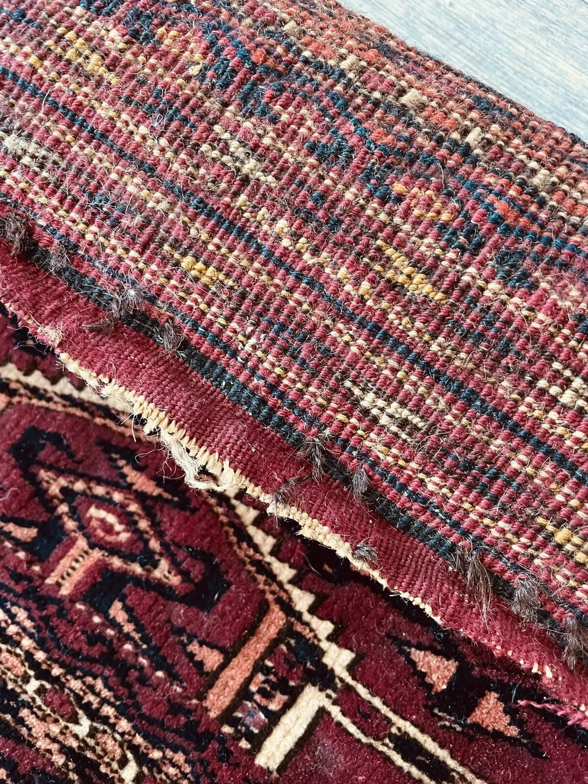 Aged wool texture with visible weave patterns of the Yomud rug