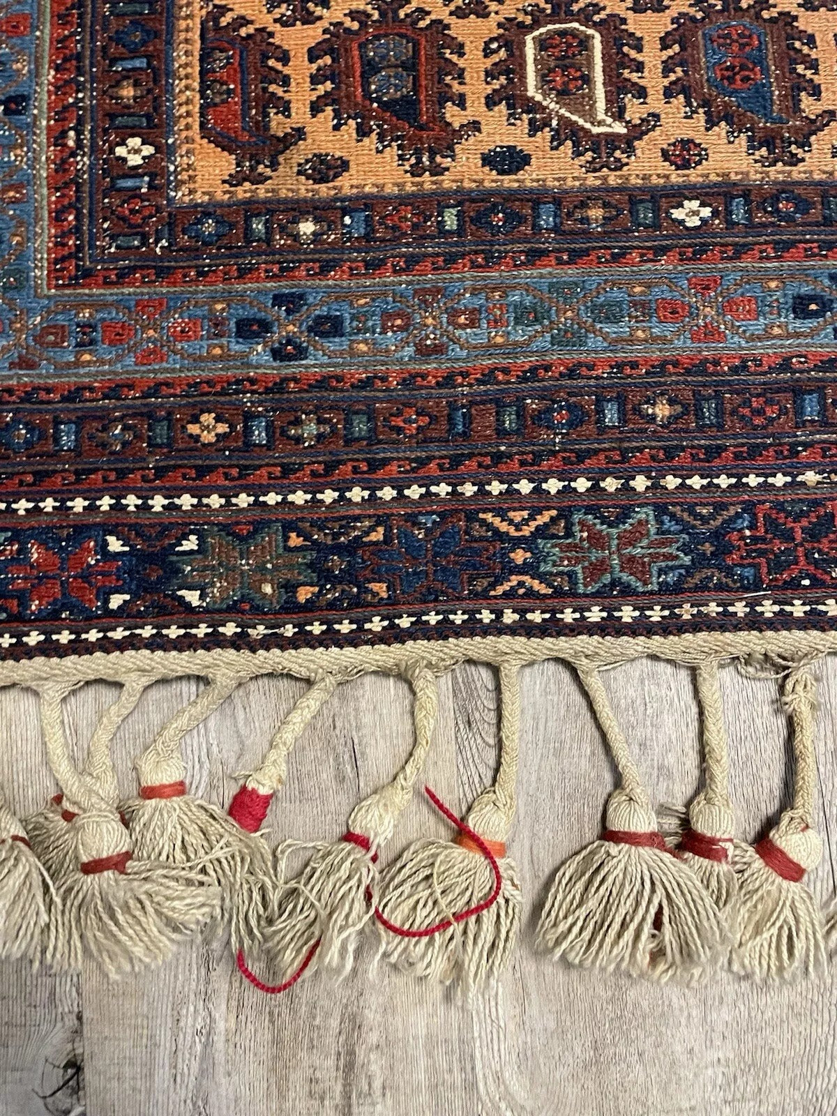 Vintage wool Sumak rug featuring earthy tones and traditional designs