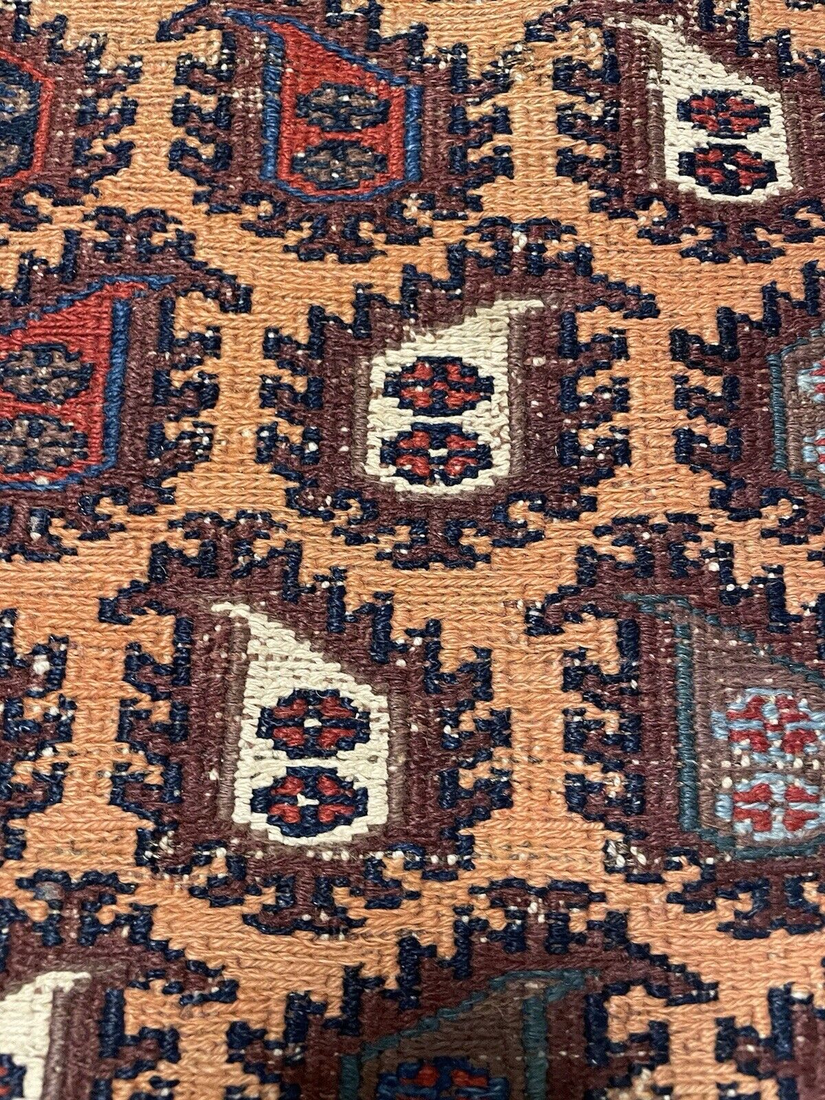 Antique Afghan rug featuring bold tribal symbols in rich colors