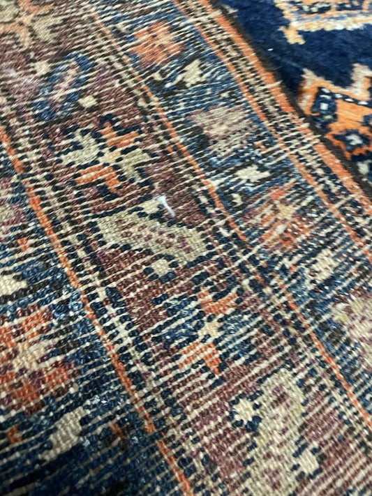 Vintage wool Persian rug with a striking central medallion design