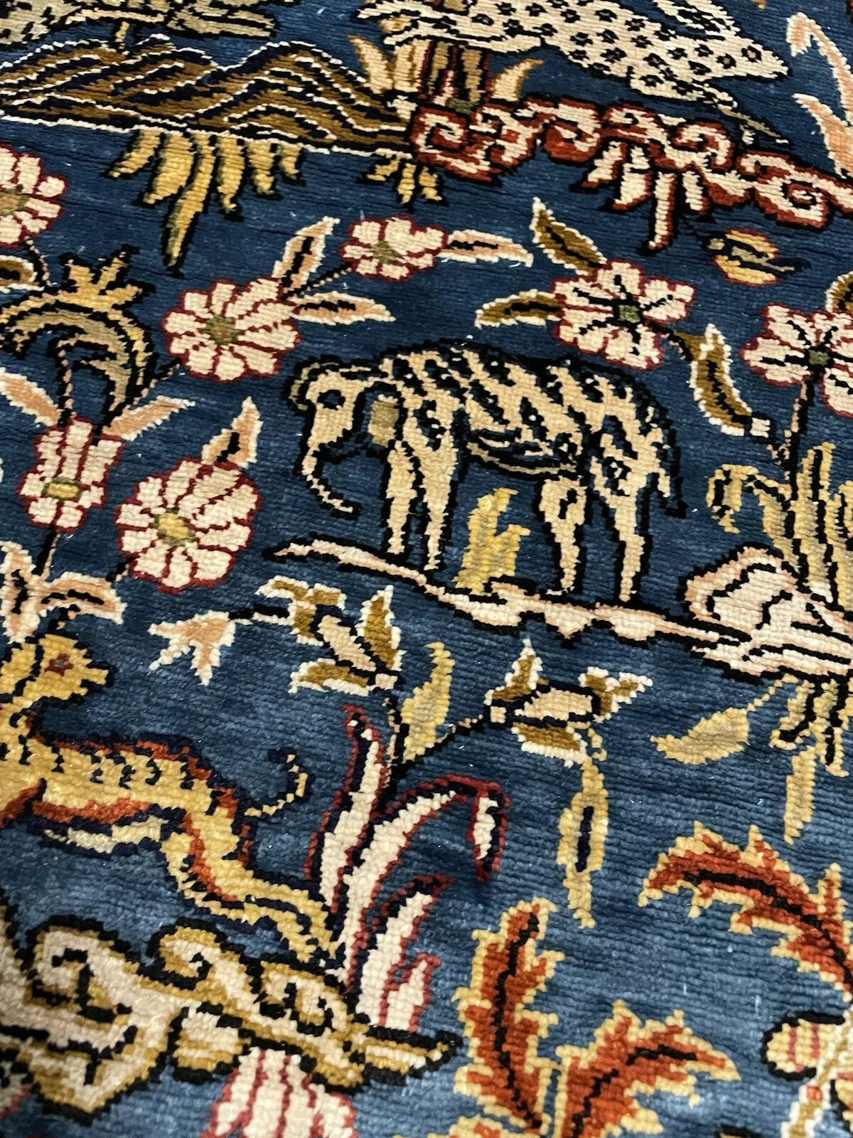 Antique-style Hereke silk rug featuring nature-inspired designs.