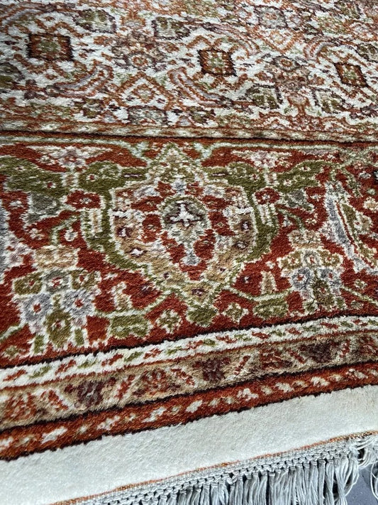 Close-up of intricate handwoven wool design on a 1970s Agra rug.