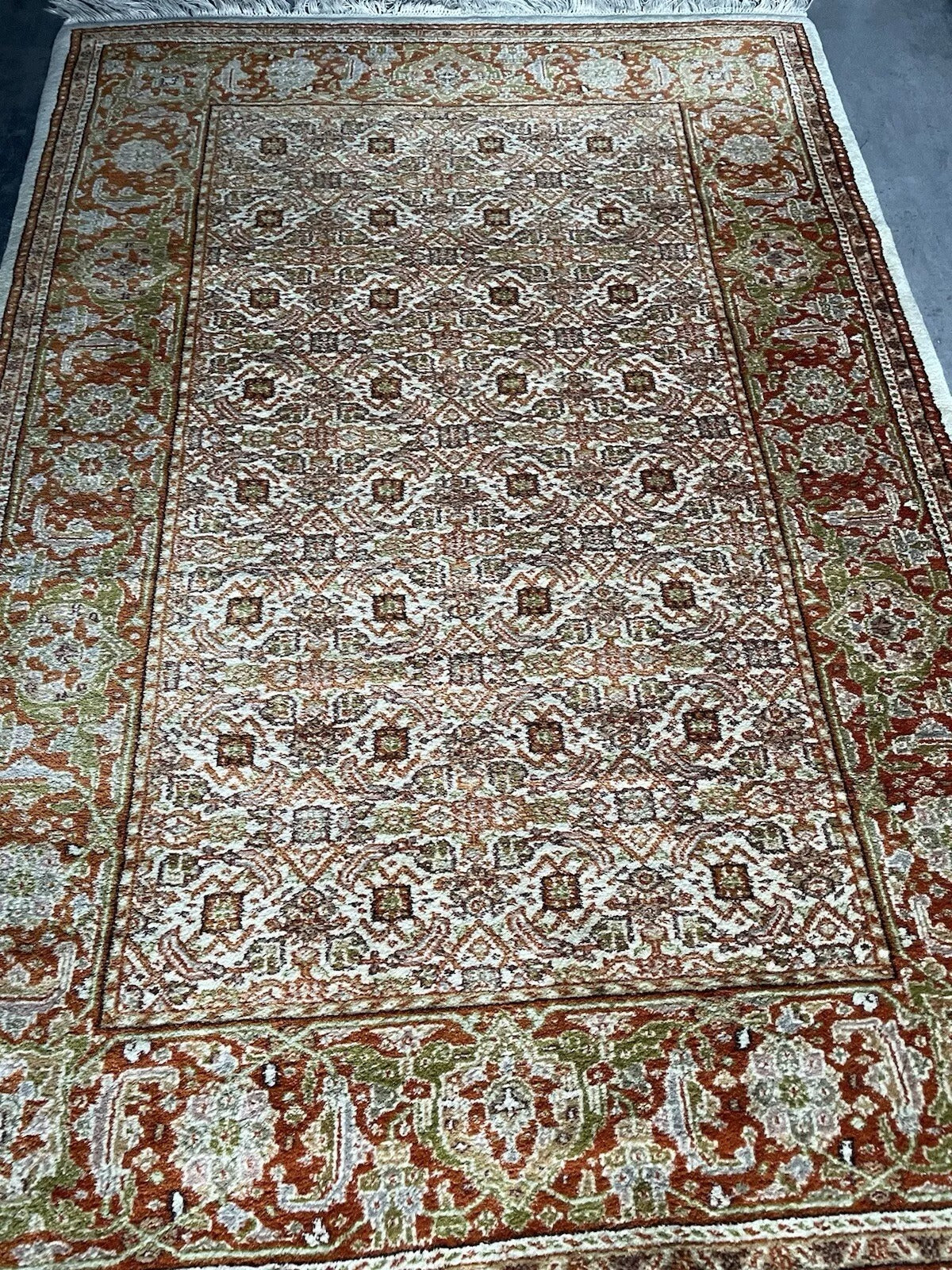 Floral and geometric elements in a vintage Agra carpet.