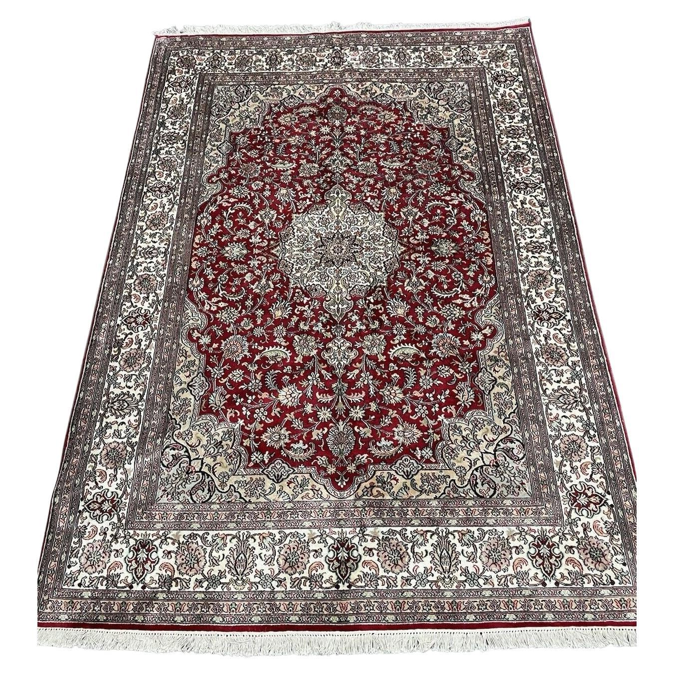 Full view of handmade vintage Persian silk Qum rug in cream and red