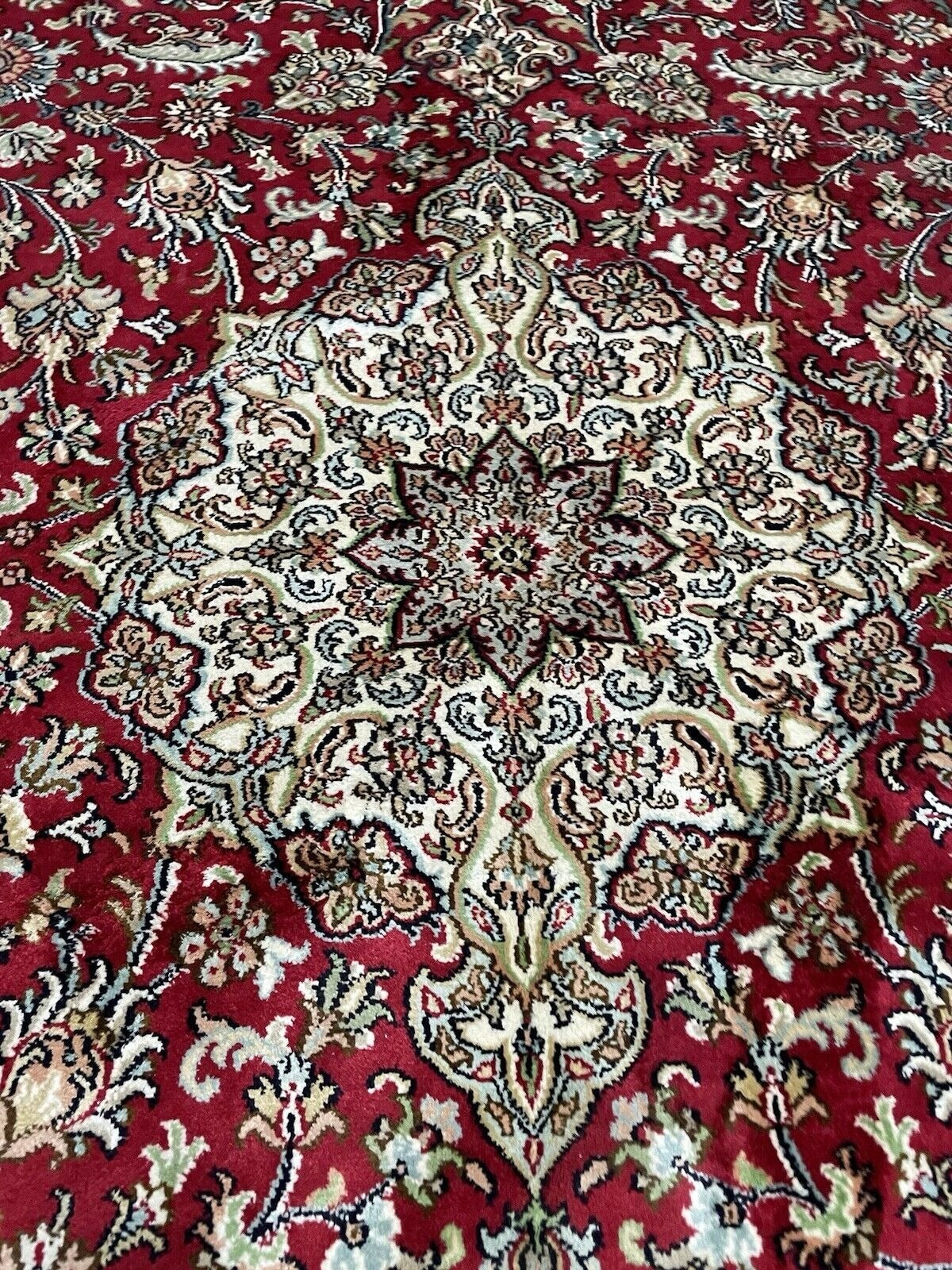 Detailed silk fringe edge of handmade Qum carpet