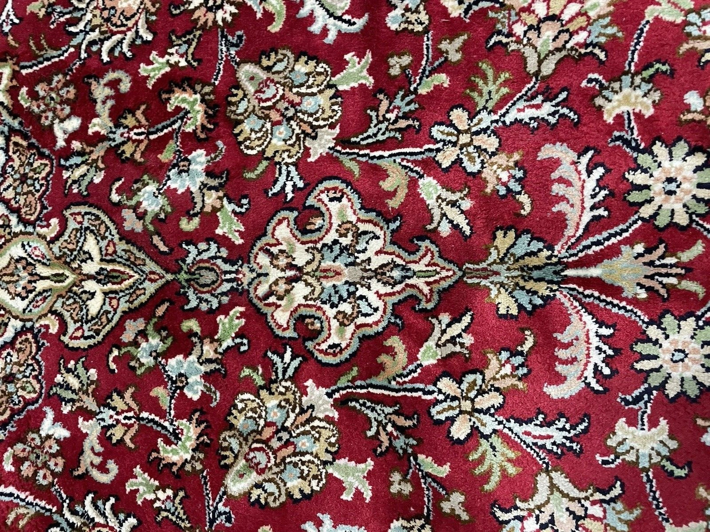 Color-rich floral symmetry of Persian Qum rug