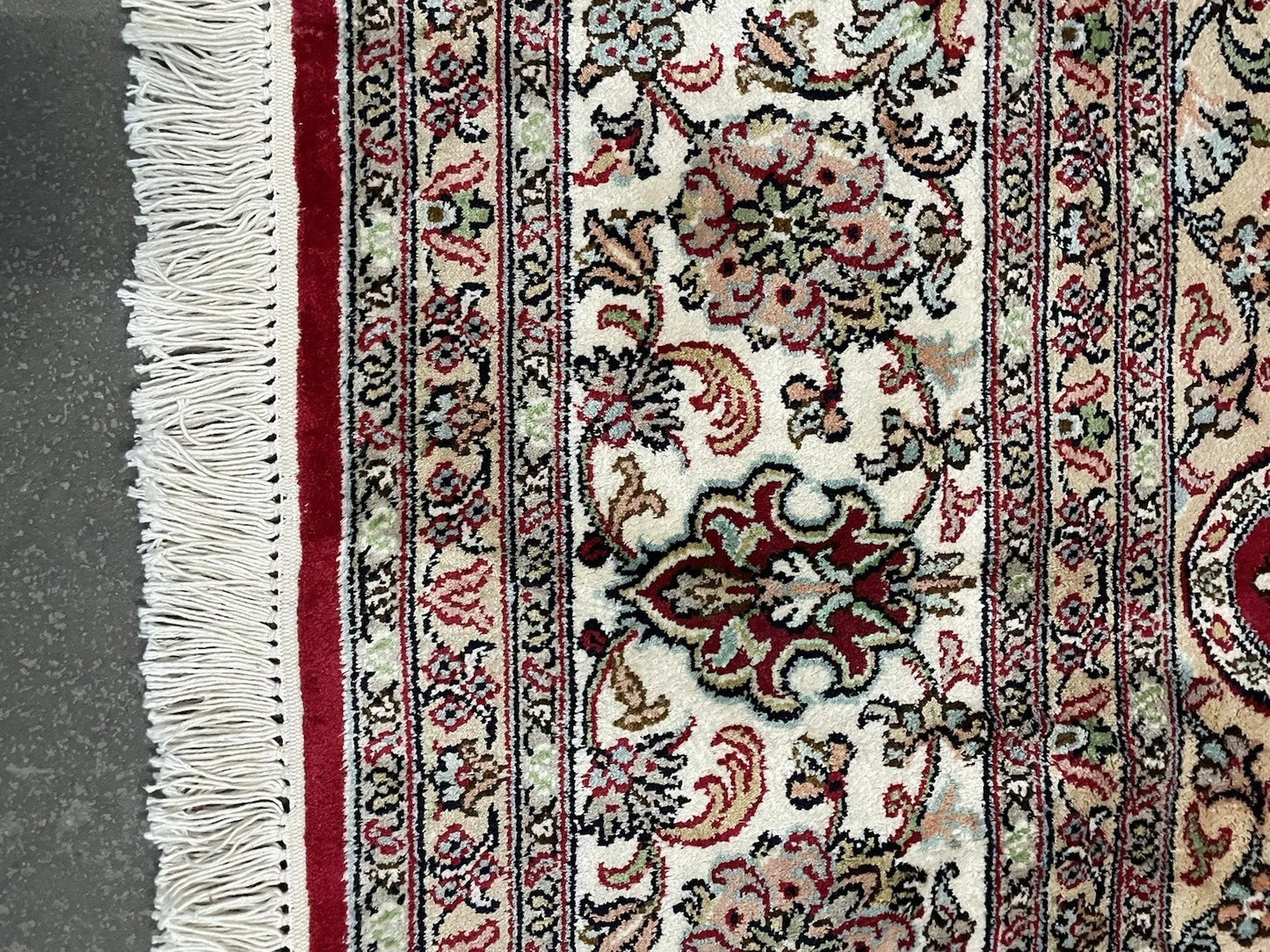 Close-up of central floral medallion on silk Qum rug