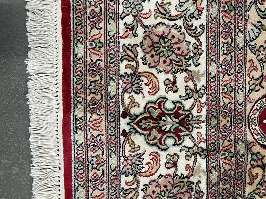 Close-up of central floral medallion on silk Qum rug