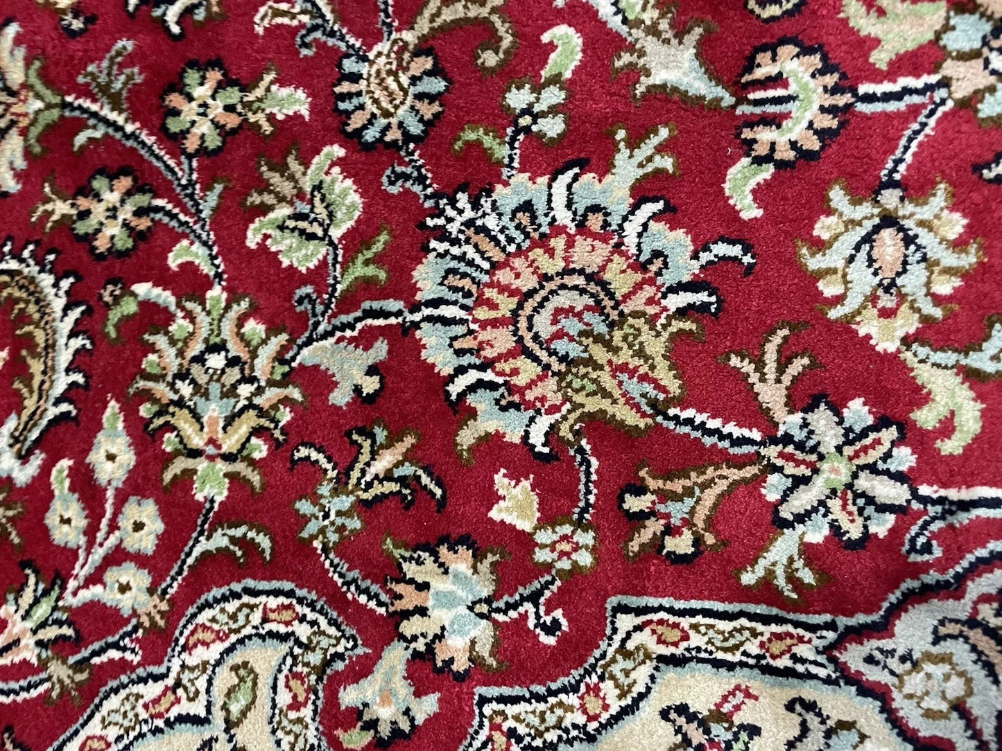 Elegant corner design on handmade silk Persian rug