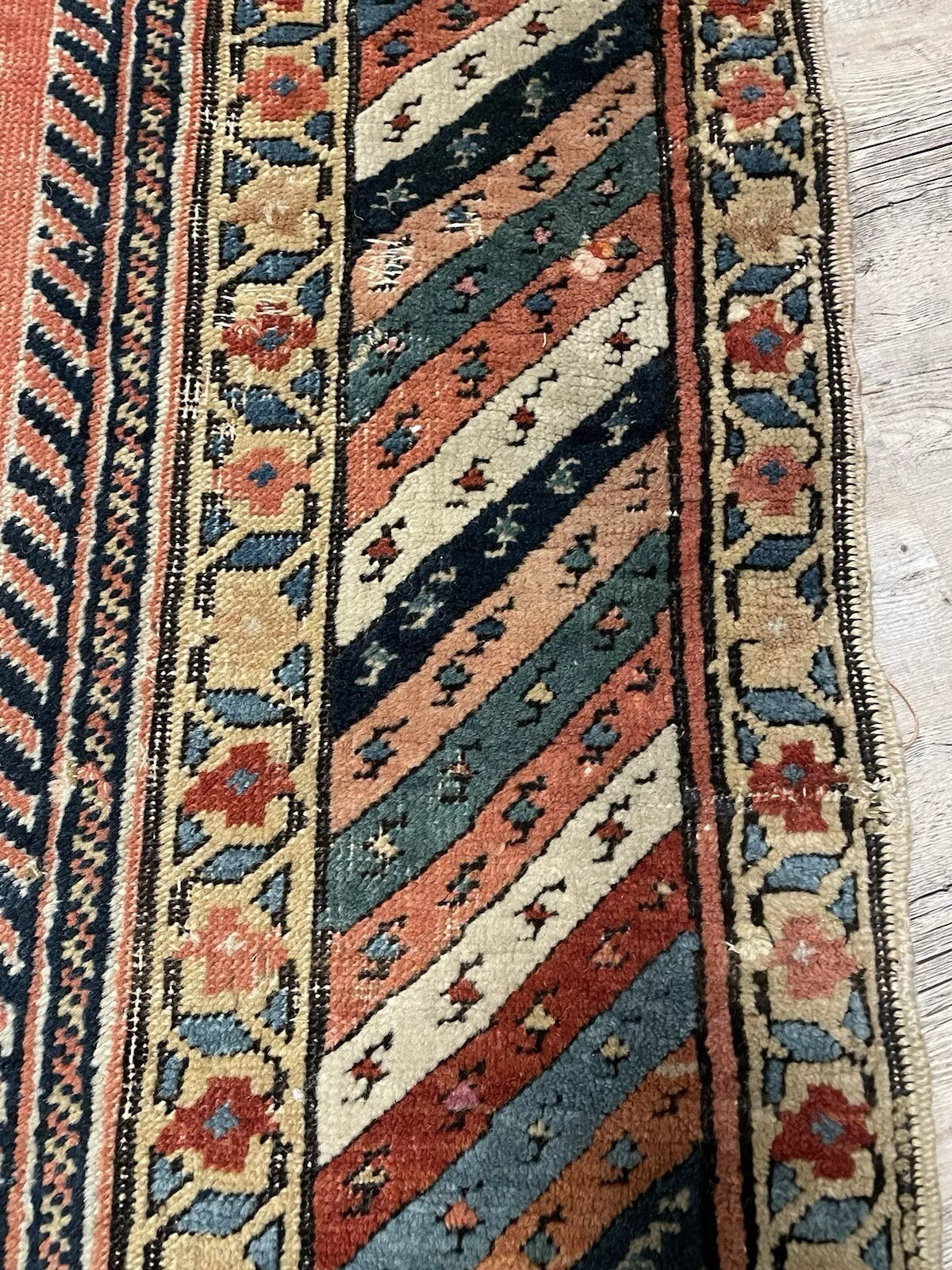 Close-up of wool pile showing tribal gul design and color contrast