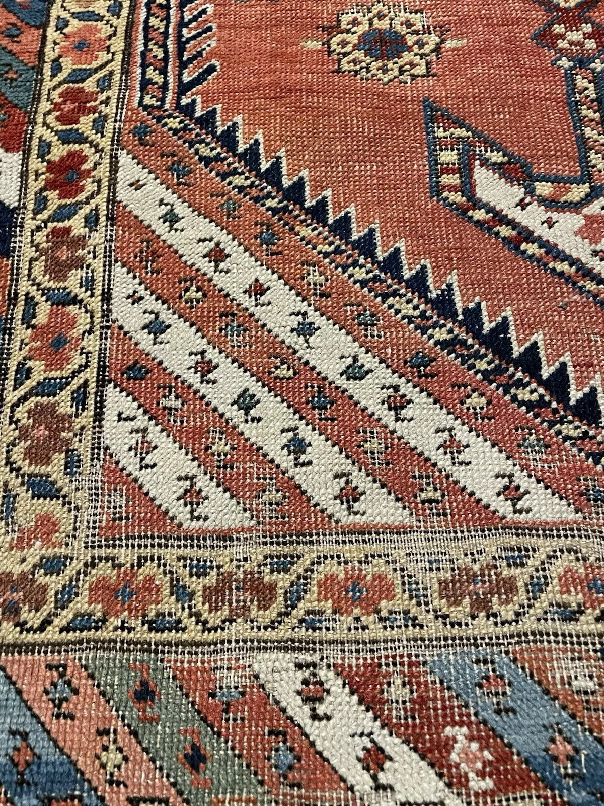 End view of antique Kurdish carpet with geometric border