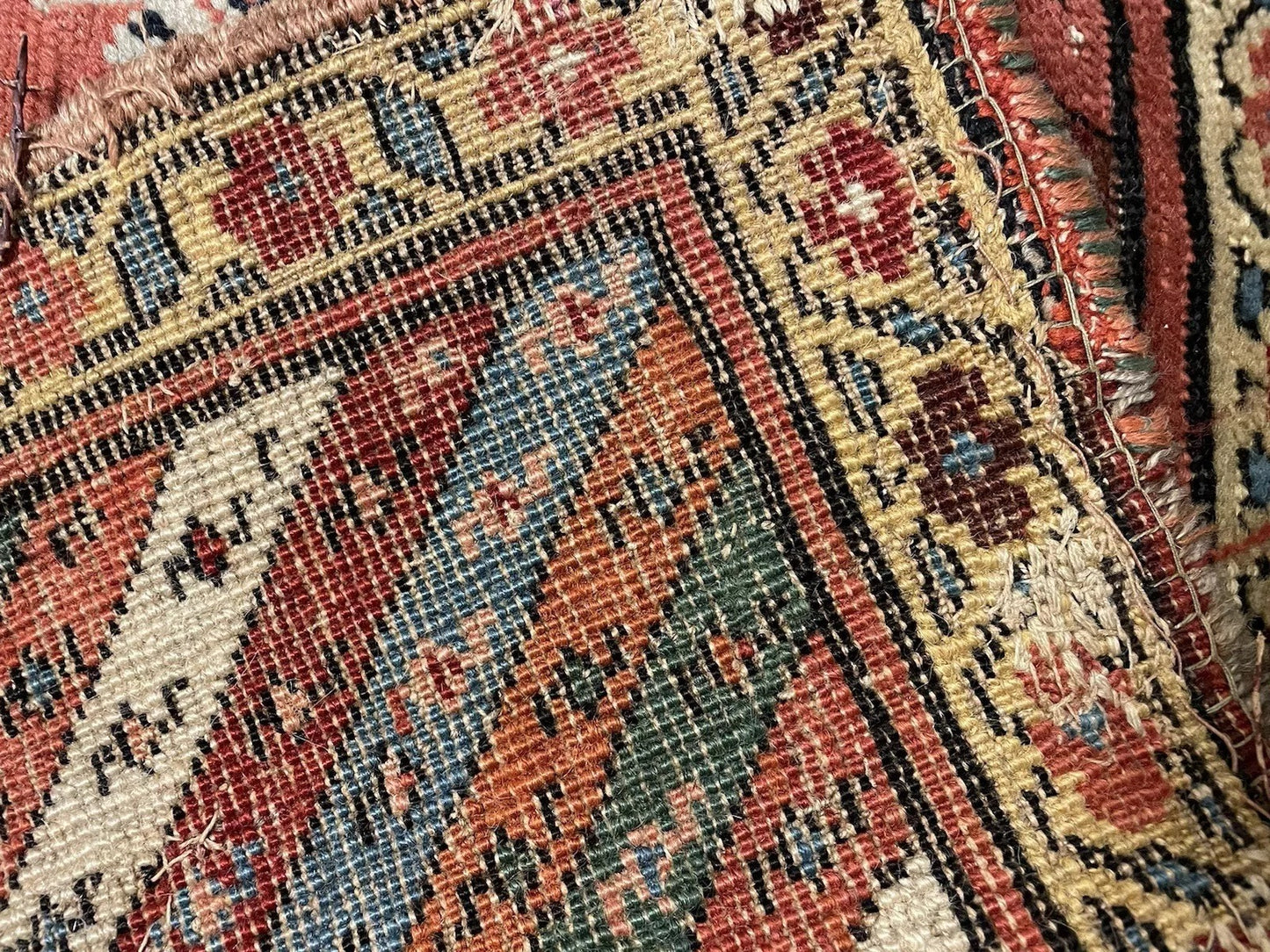 Indigo and red motif close-up on 19th-century Kurdish rug