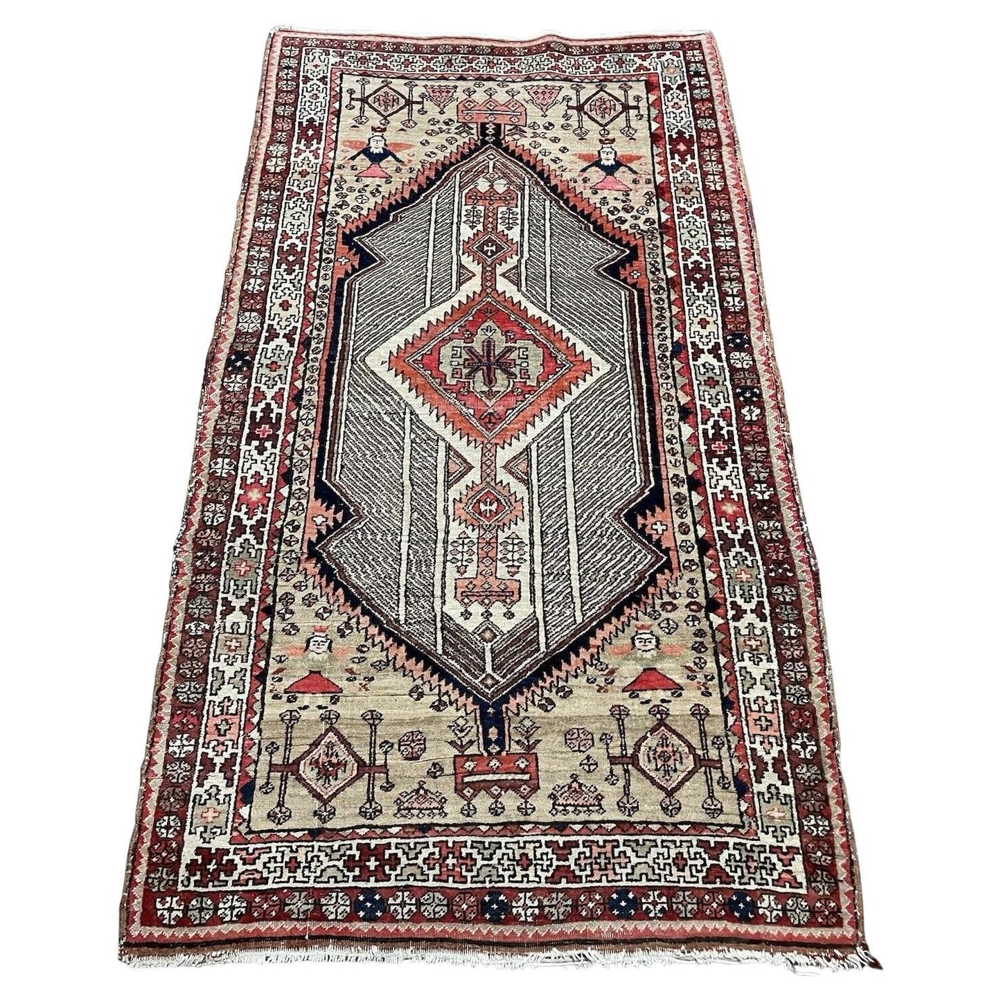 Antique Persian Seraband rug featuring repeating boteh motifs on straw‑sand field