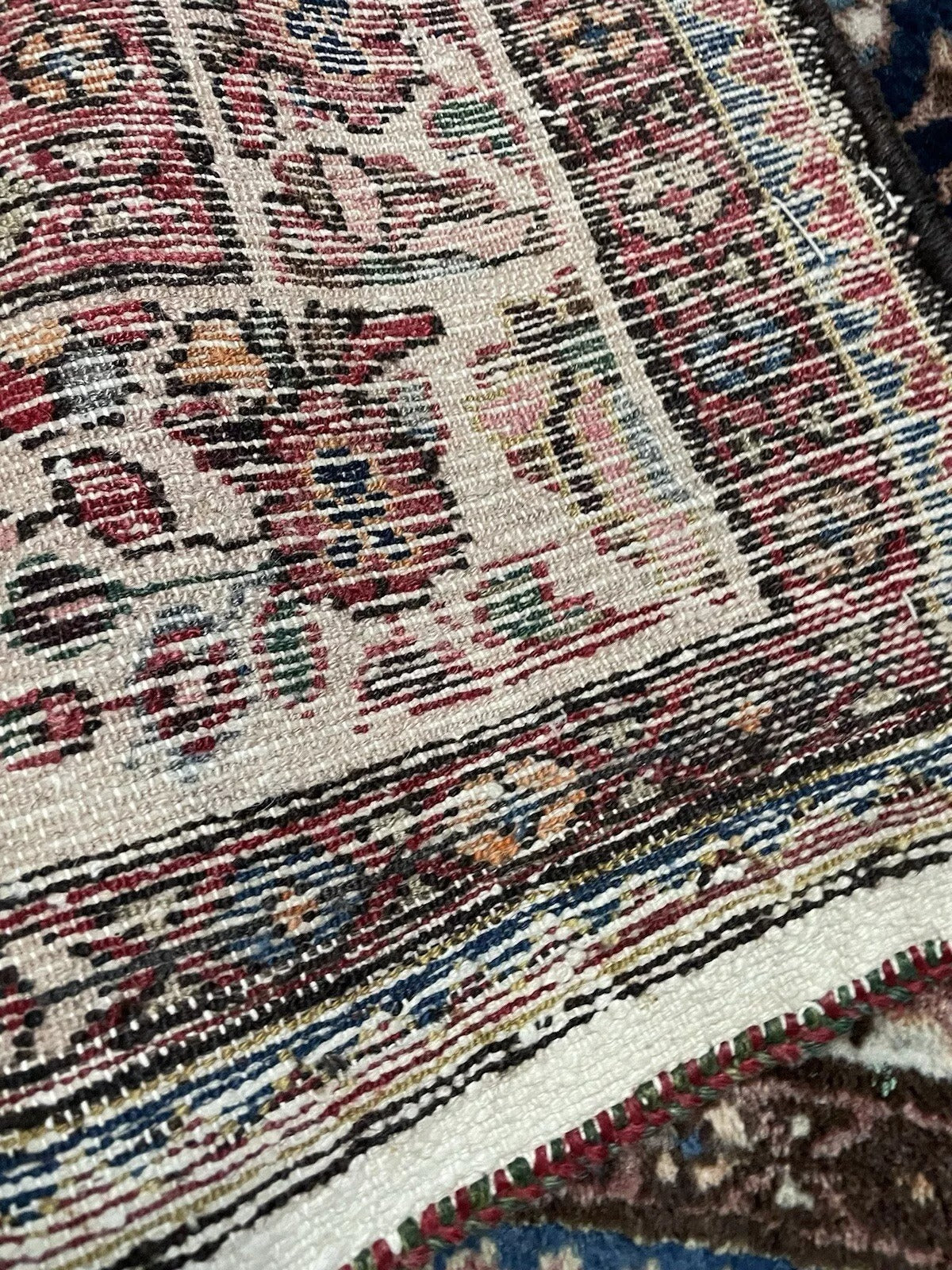 Rich color variation in antique Hamadan rug pattern