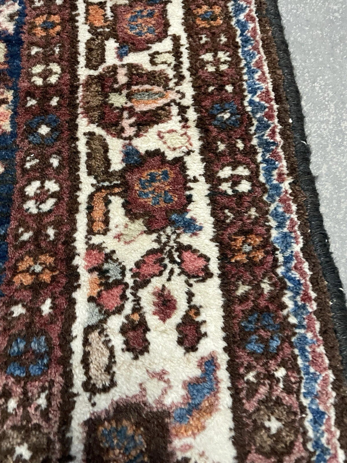 Detail of repeating tribal motifs on Hamadan carpet