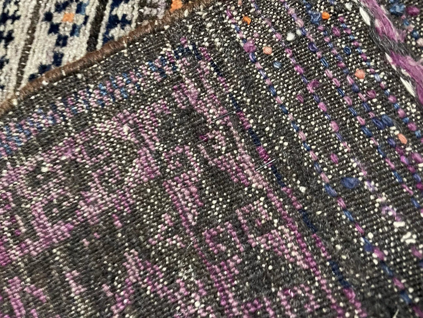 Geometric hooked border detail on antique Baluč carpet