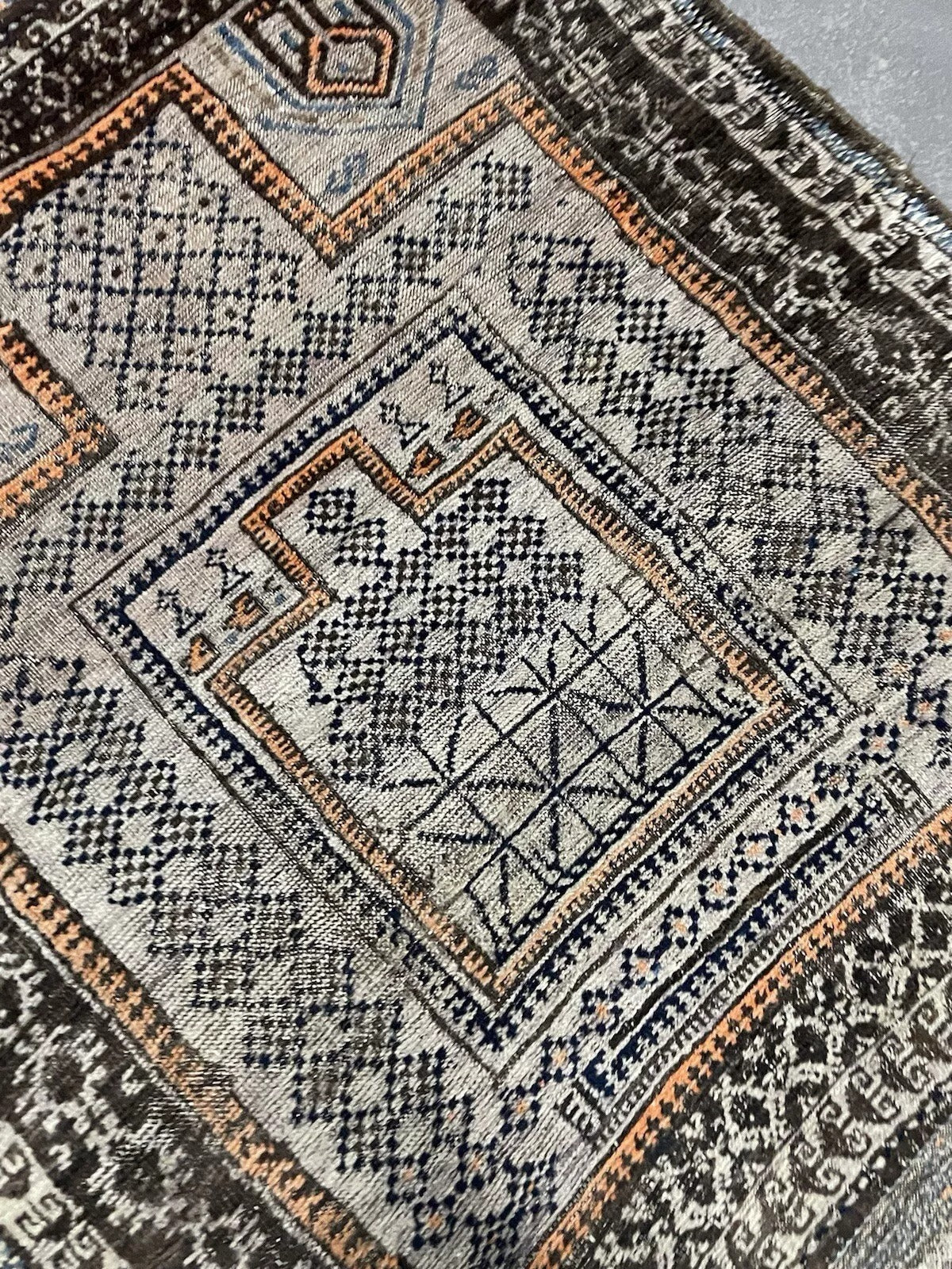 Compact wool medallion pattern on vintage Baluč rug