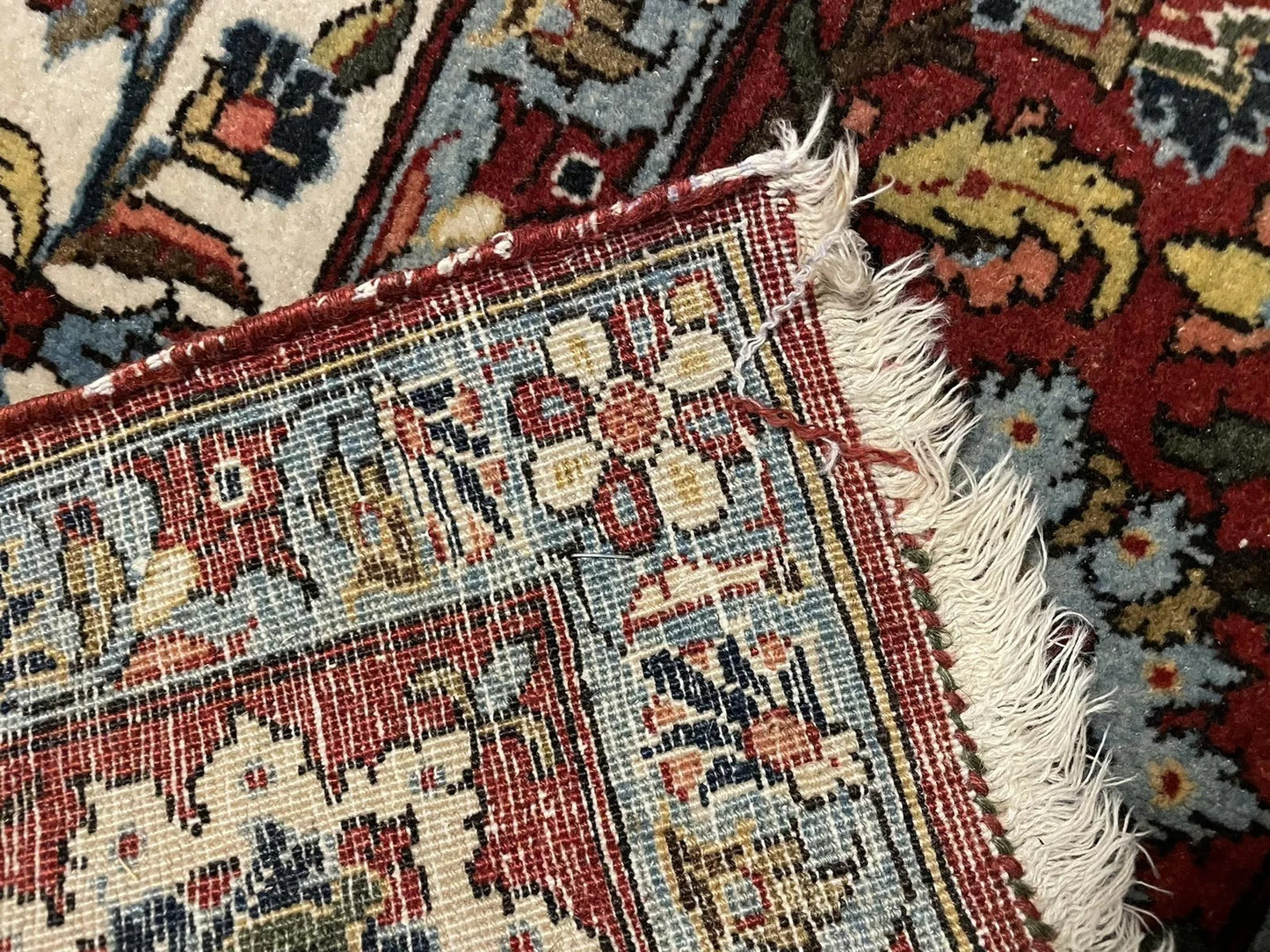 Terracotta and ivory floral motifs in Persian carpet