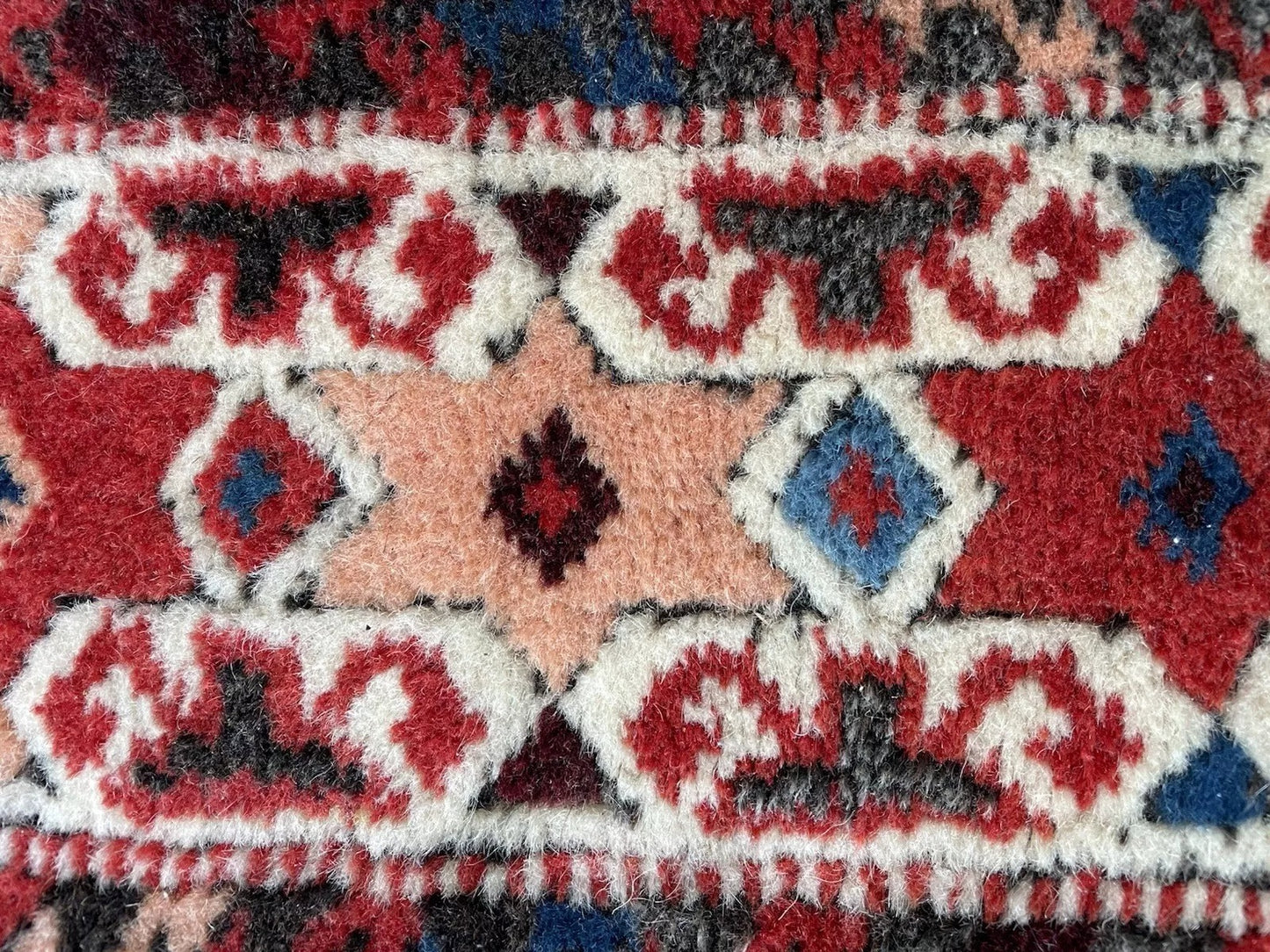 Bold red central field framed by geometric borders