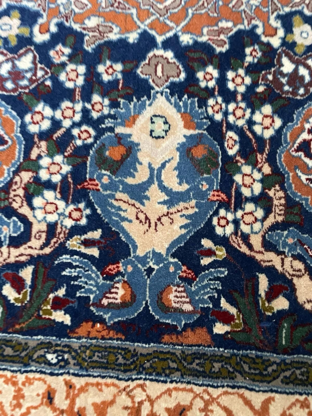 Corner of Isfahan rug featuring delicate botanical designs