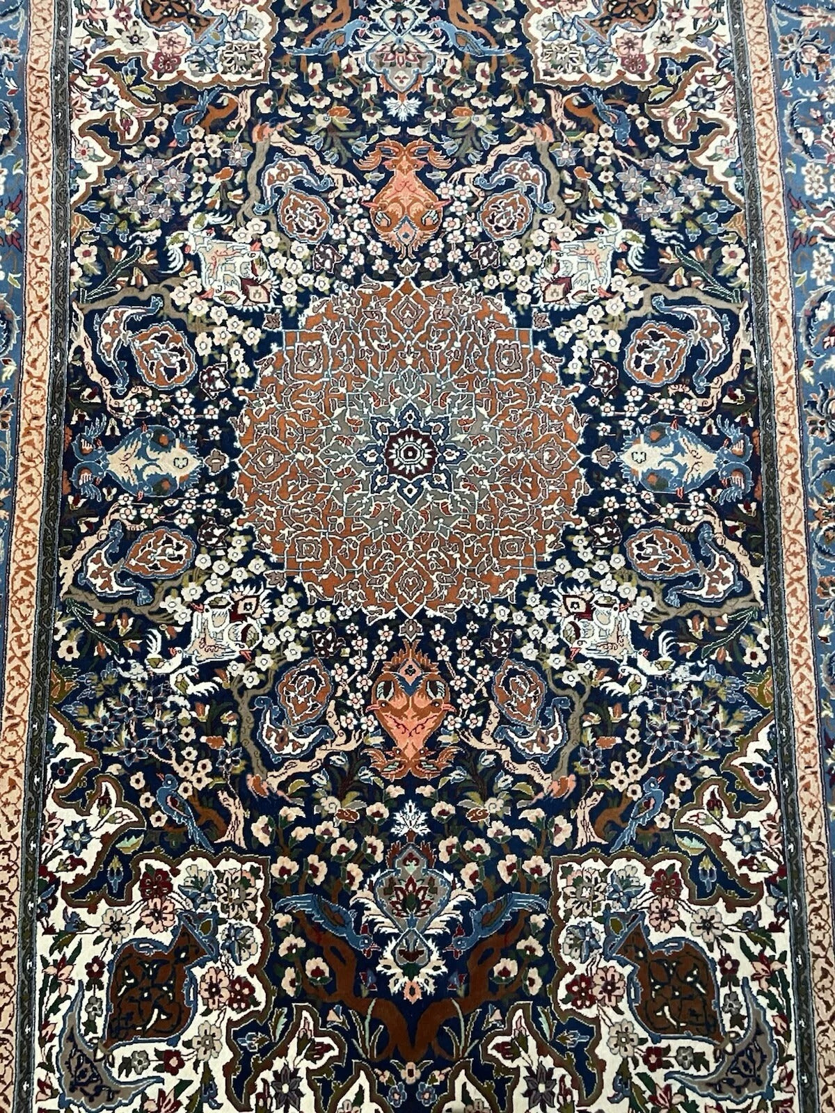 Edge border showing traditional floral motifs in gold and ivory