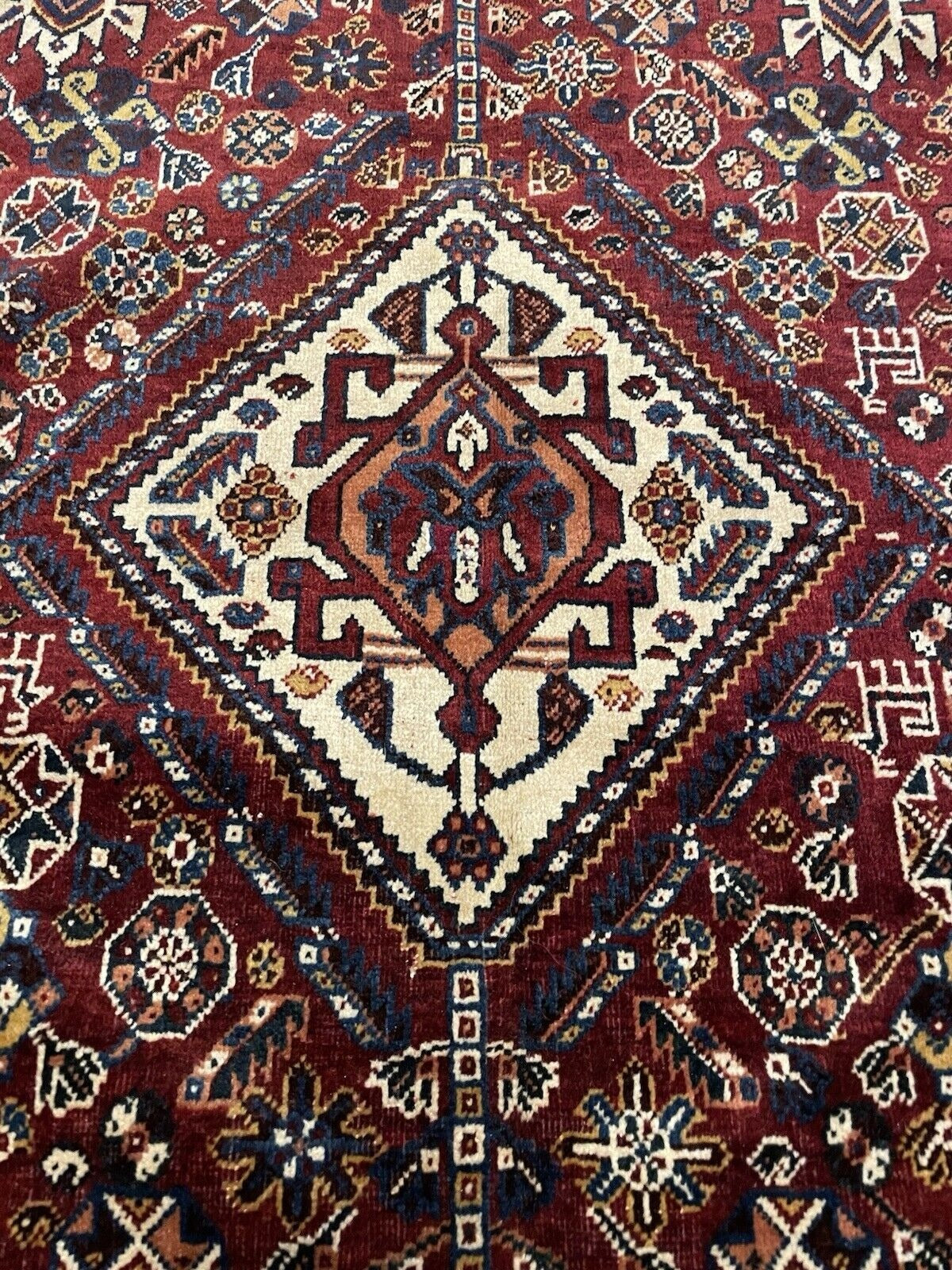 Rich red field contrasting with blue and white accents