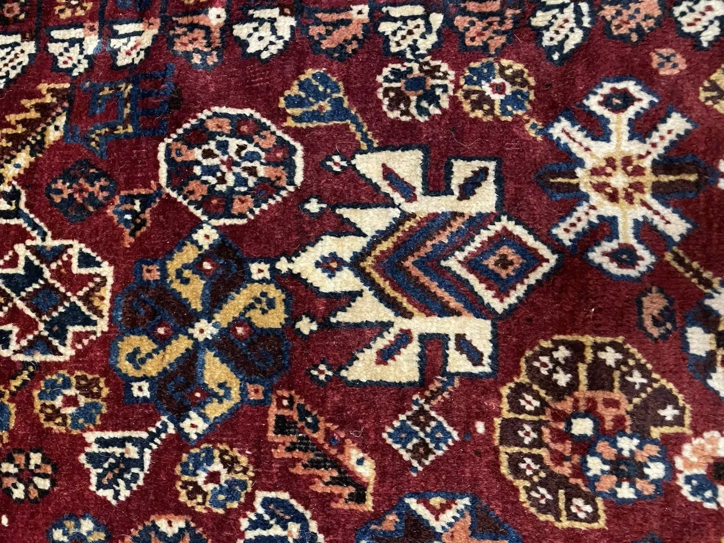 Hand-knotted wool pile detail on tribal Persian rug