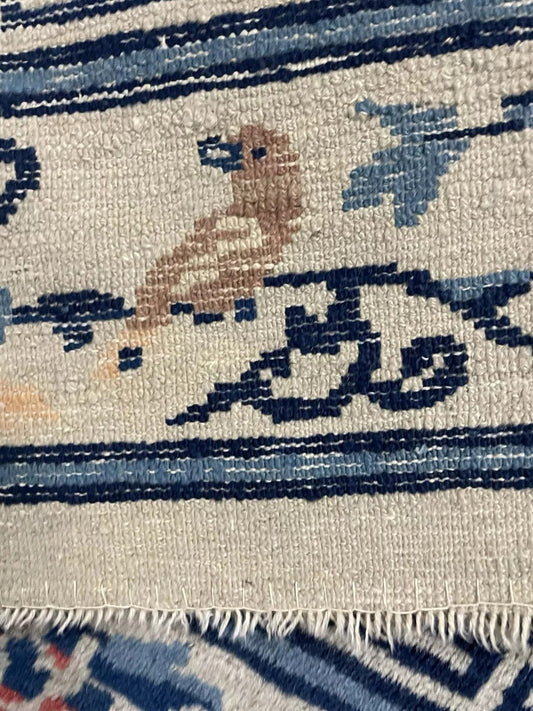 Close-up of stylized floral sprays on Feti rug