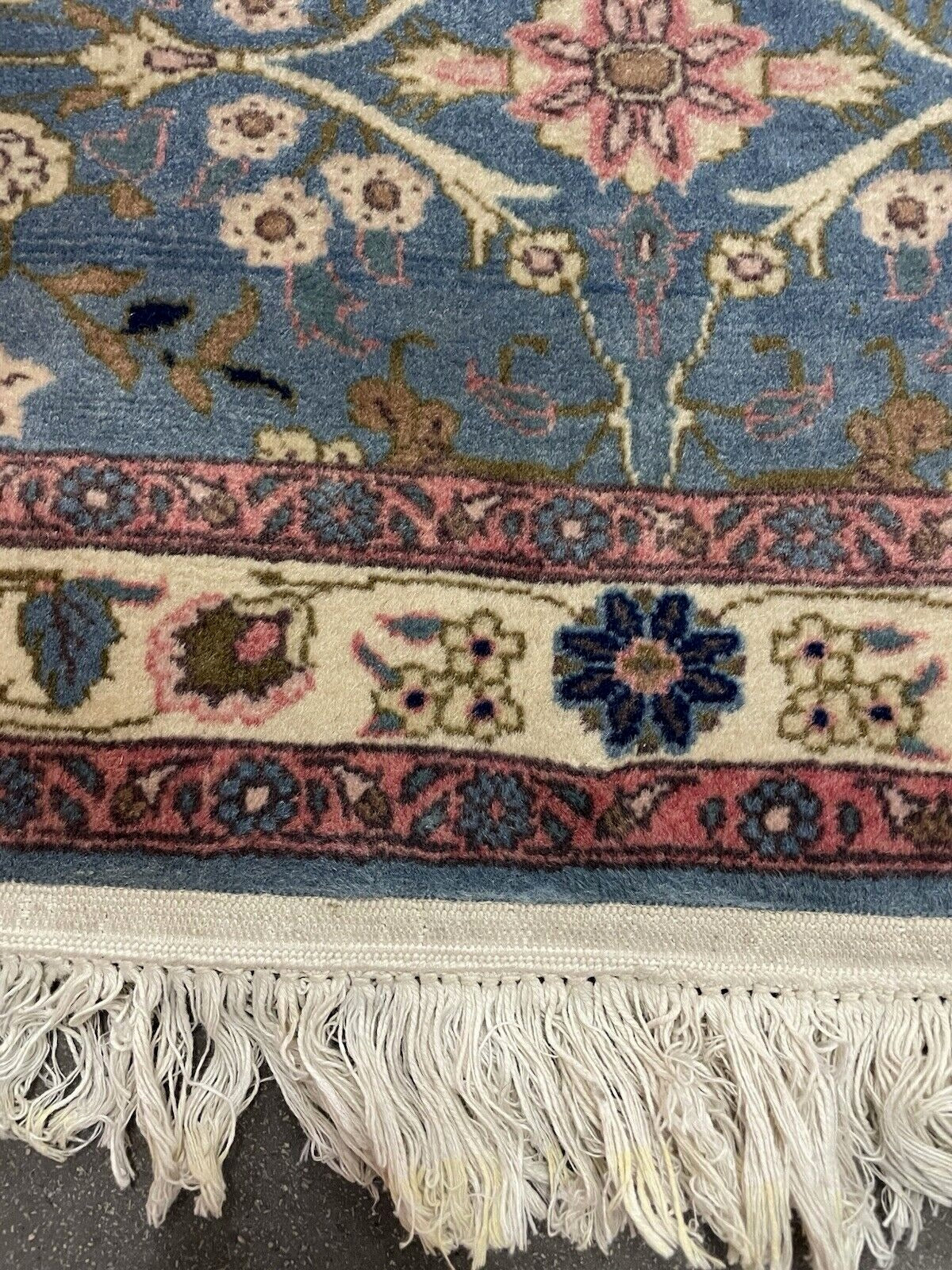 Artisanal knotwork visible on rug’s underside