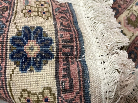 Close-up of 1920s wool rug showing natural dye variations