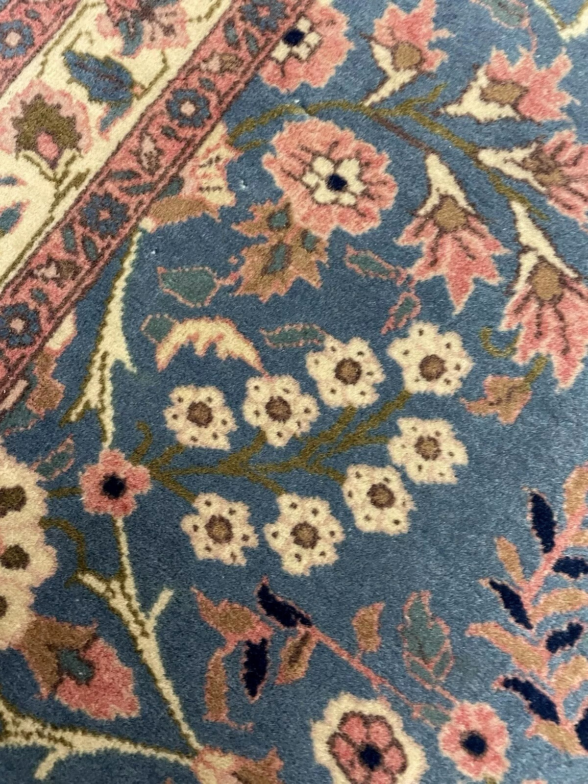 Texture of hand-knotted wool in ivory and terracotta hues