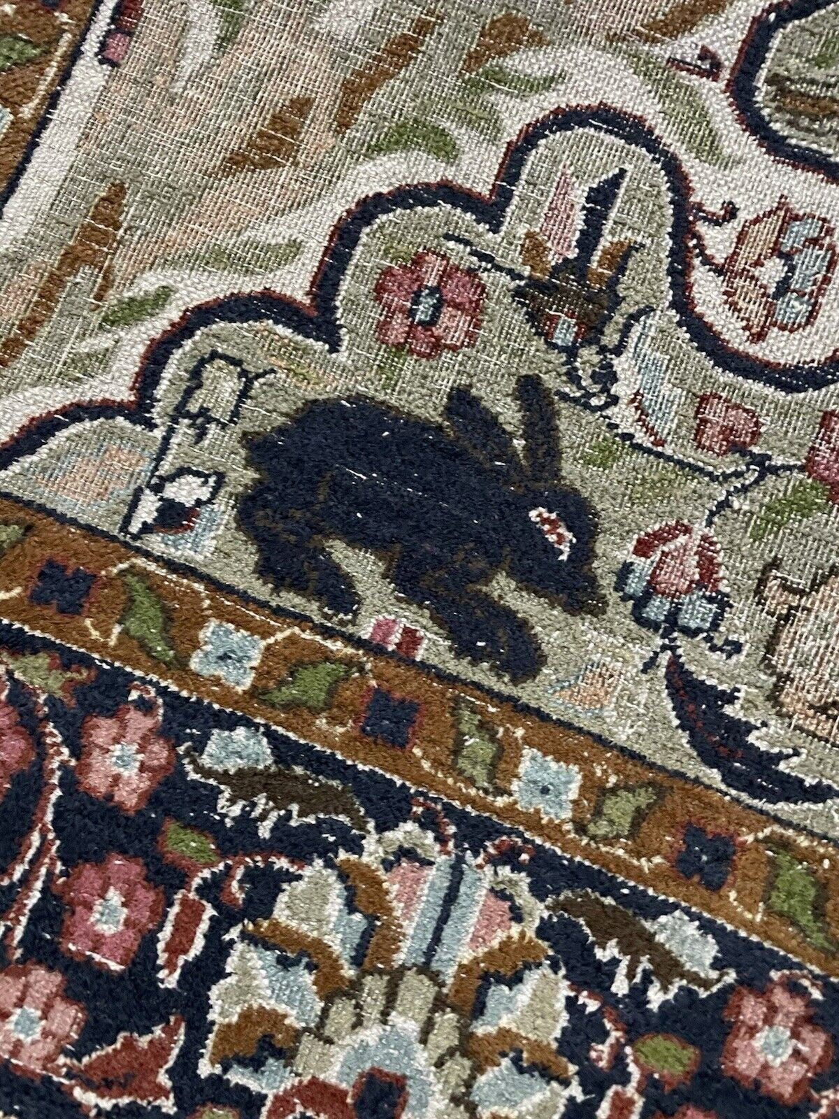 Detail of the rug's fringe, consistent with its overall antique condition.